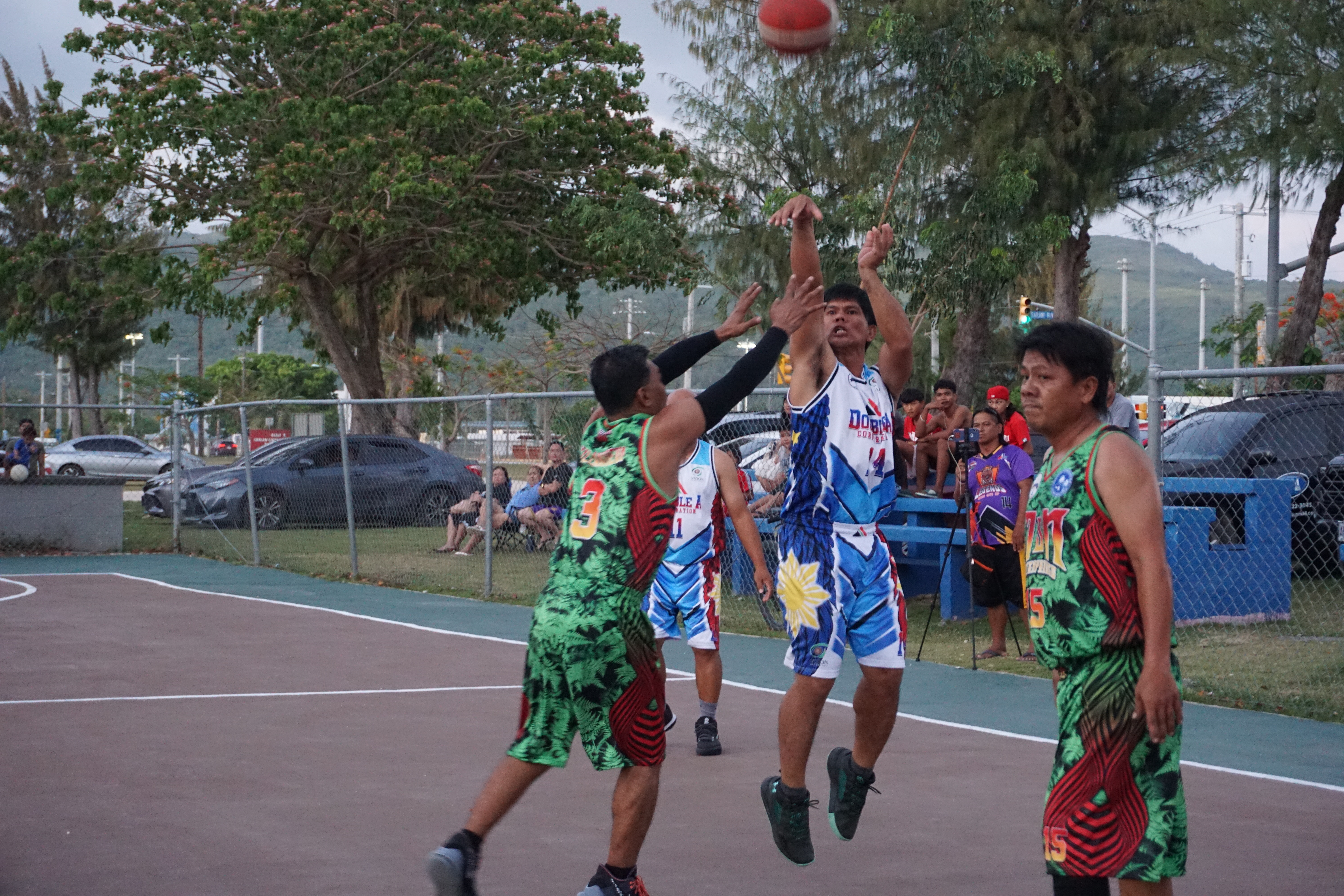 Double A's Jerry Tolentino takes the contested three-point shot during a masters division game of the Saipan Centennial Lions Club Invitational Basketball League on Saturday at the Civic Center basketball court.