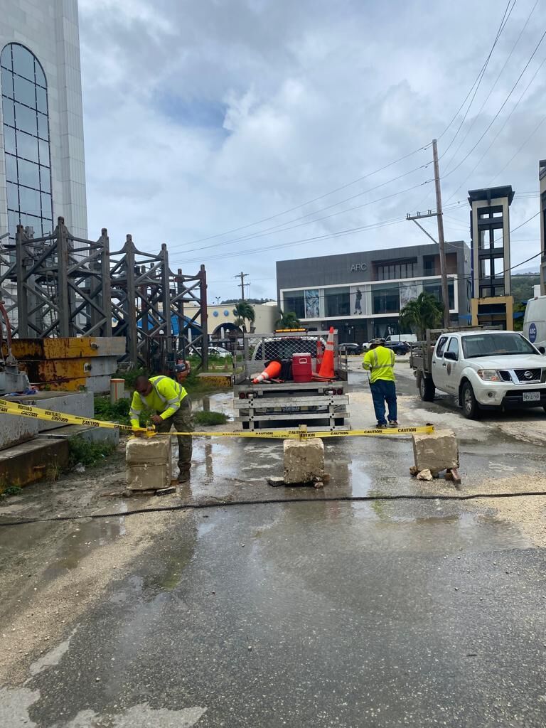 Department of Public Works staffers use concrete blocks and yellow tape to close Hibiscus Lane on Tuesday.