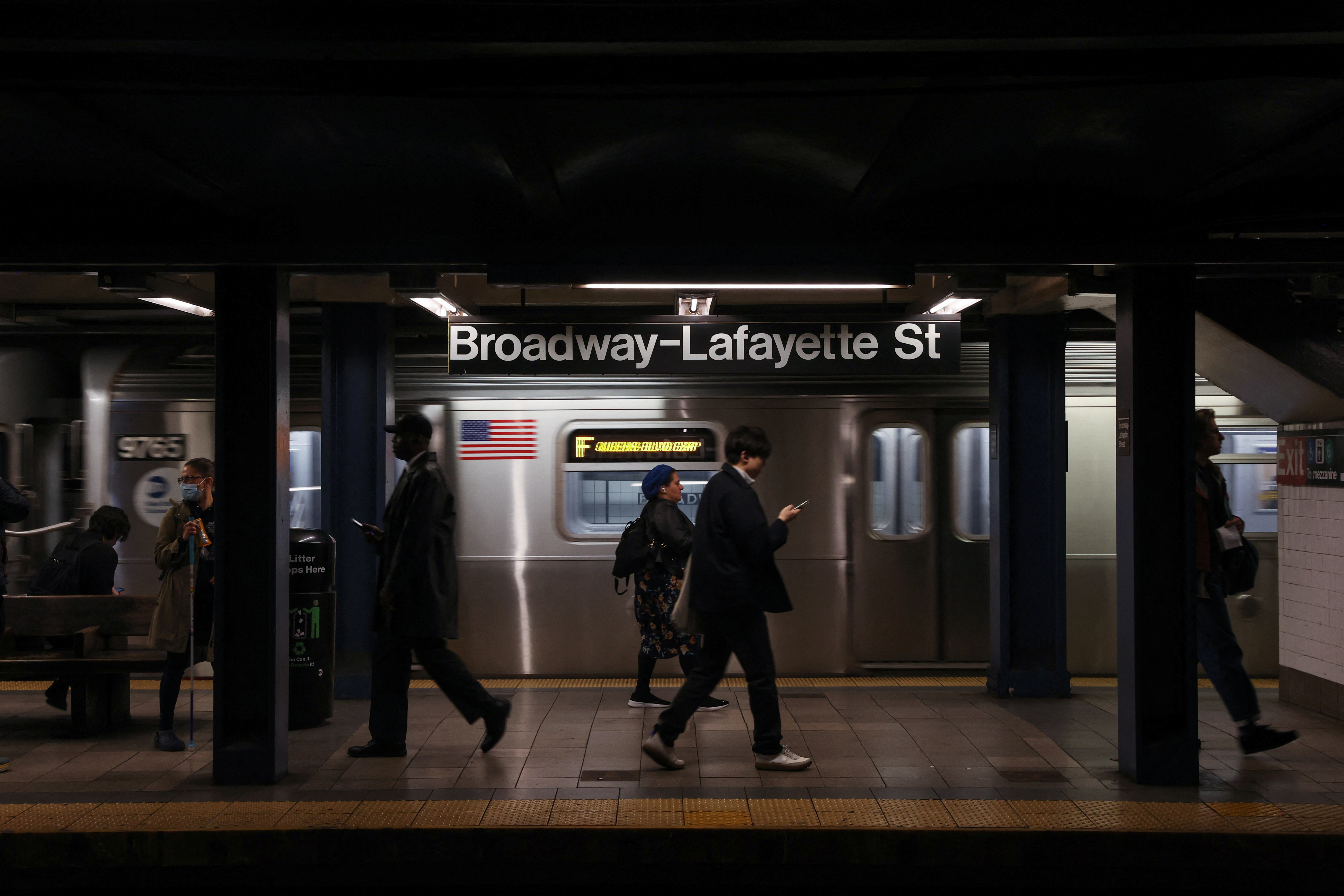 Subway riders walk at the Broadway-Lafayette subway station, after according to local media reports a 30-year-old man acting erratically on a F subway train died on Monday afternoon after a fellow rider restrained him with a chokehold according to the police and a video of the encounter, in New York City, U.S., May 3, 2023. REUTERS/Shannon Stapleton