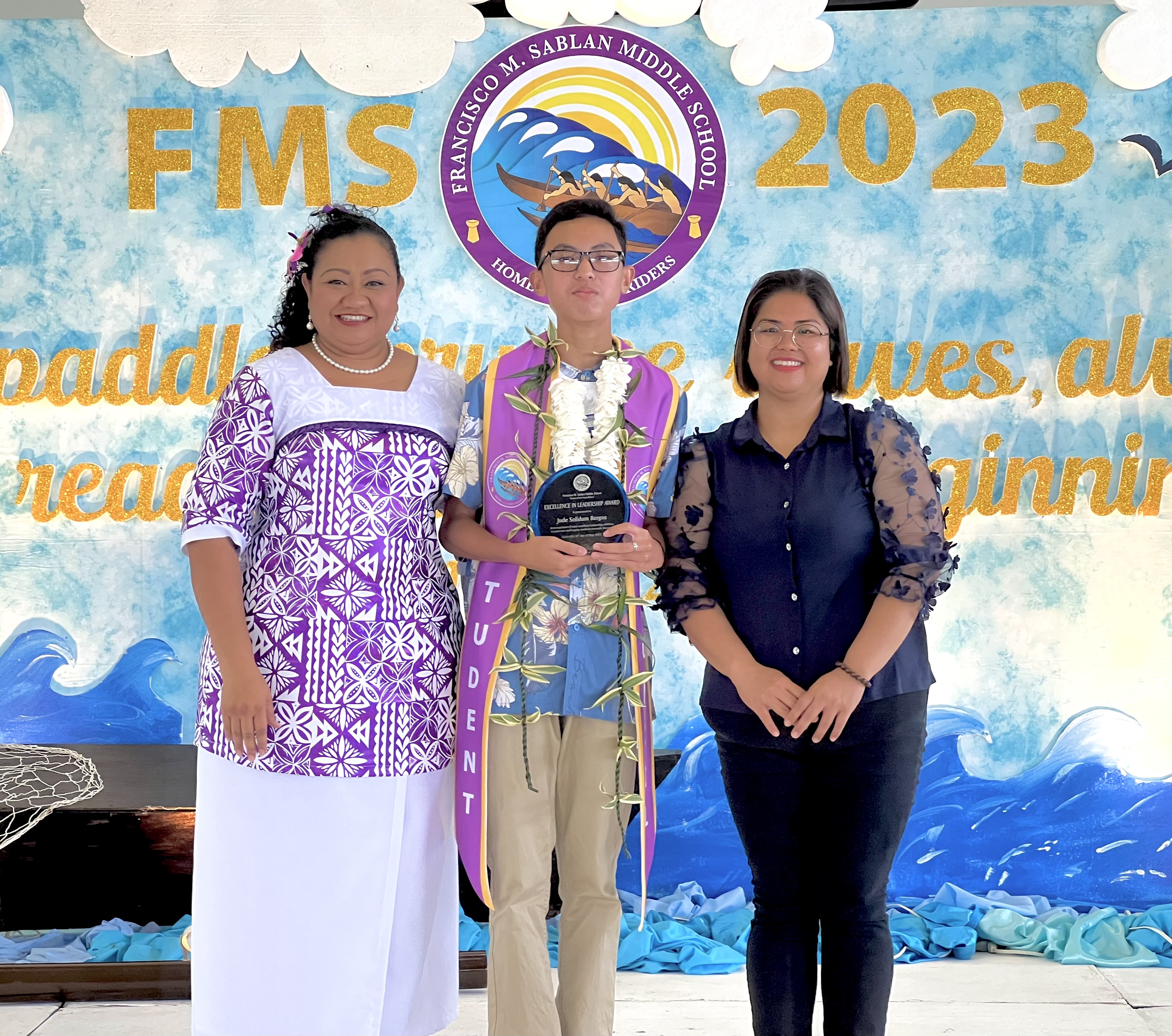  The Excellence in Leadership Award was presented to Jude Solidum Burgos, center, by FMS Principal Cherlyn Cabrera Osung, left, and Vice Principal Catherine Acera-Cabrera.