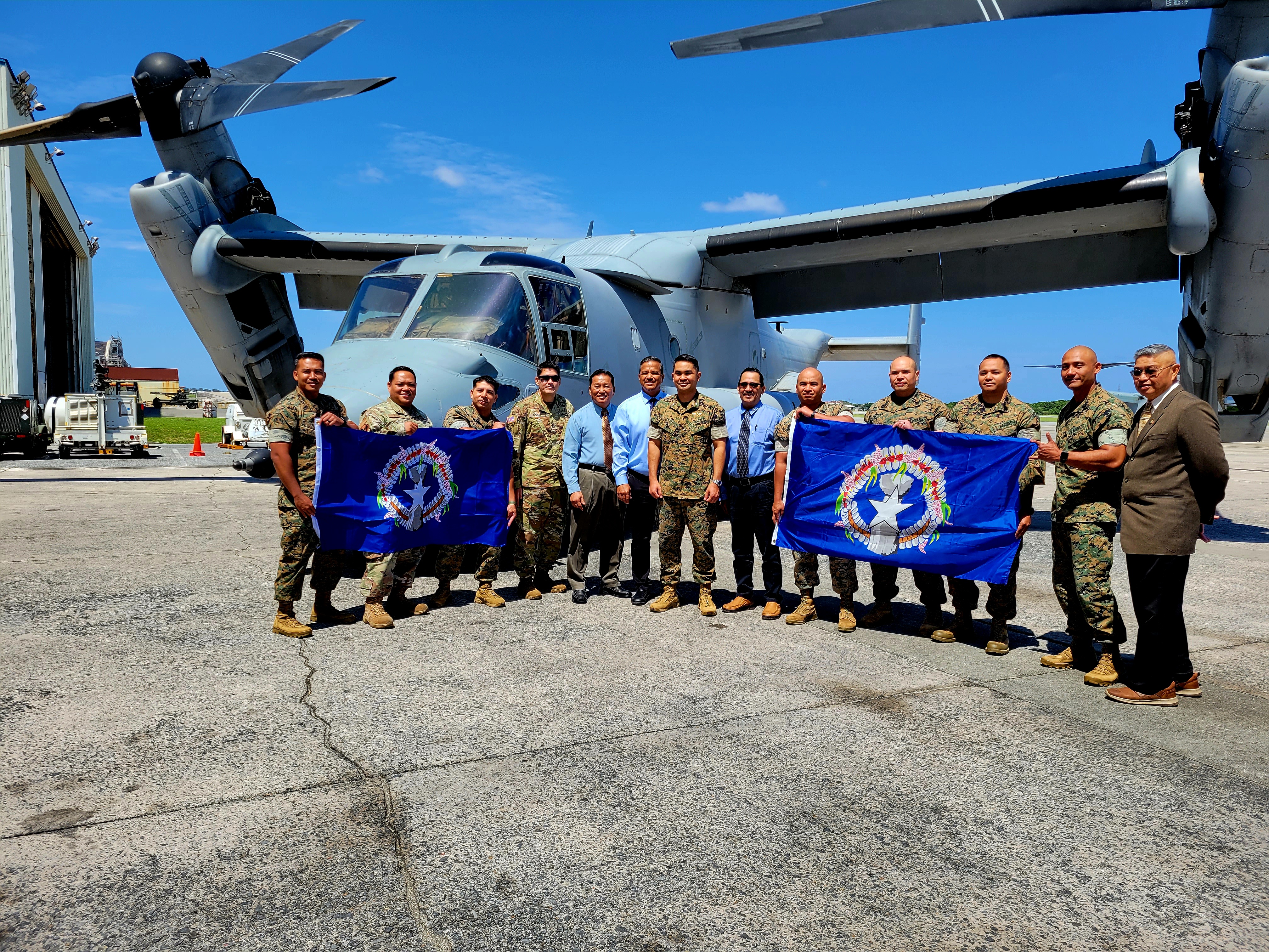 Lt. Col. Adrian R. Evangelista, center, poses for a photo with Sen. Frank Q. Cruz, fifth left, Sen. Jude Hofschneider, sixth left, Rep. Patrick San Nicolas, sixth right, and members of the Marine Medium Tiltrotor Squadron 262 next to an Osprey at the Marine Corps Air Station Futenma, Okinawa, Japan on May 11, 2023.