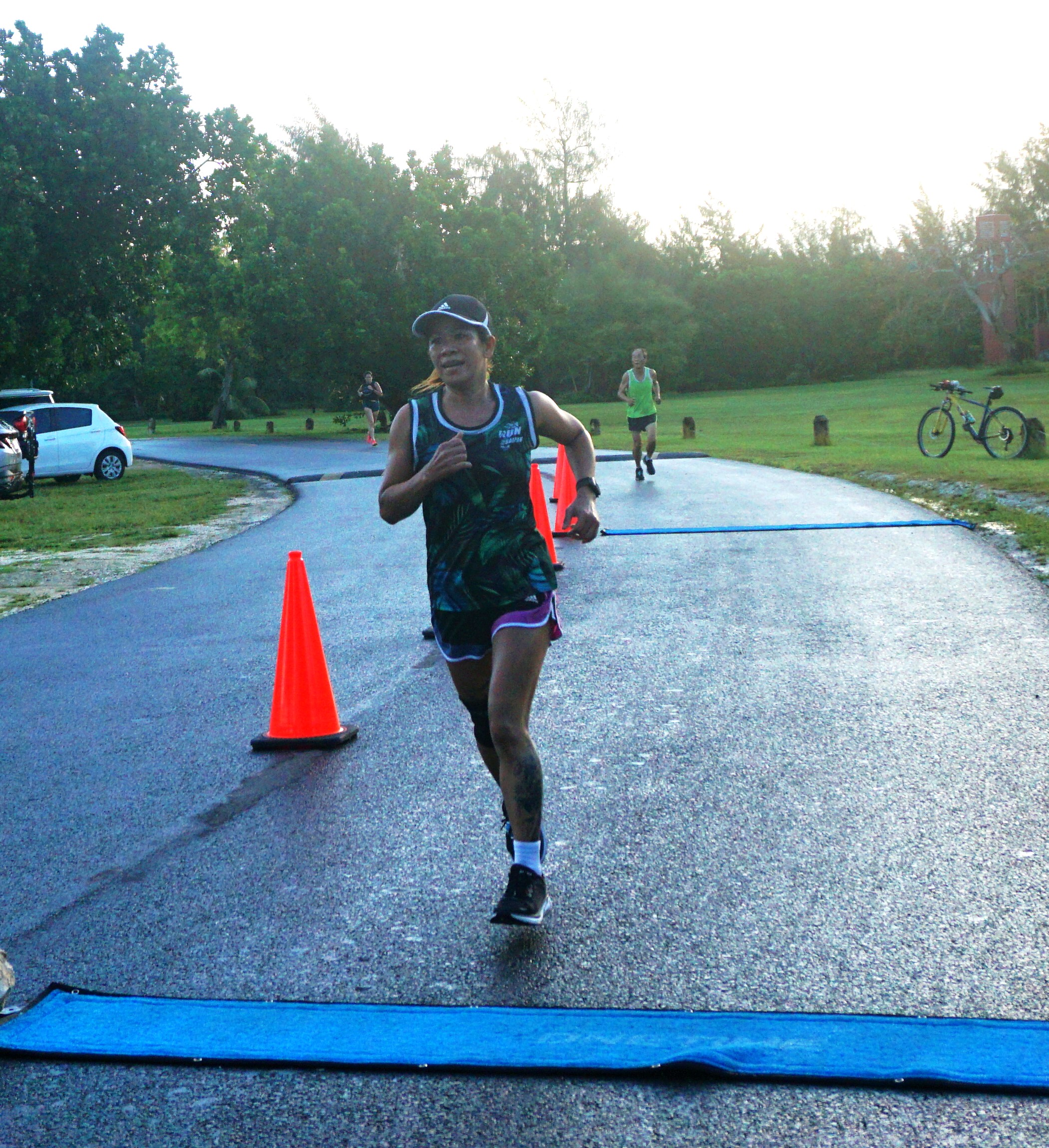 Rosemarie Chisato smiles as she crosses the finish line of Run Saipan’s Mangrove 5K Run Saturday at American Memorial Park.