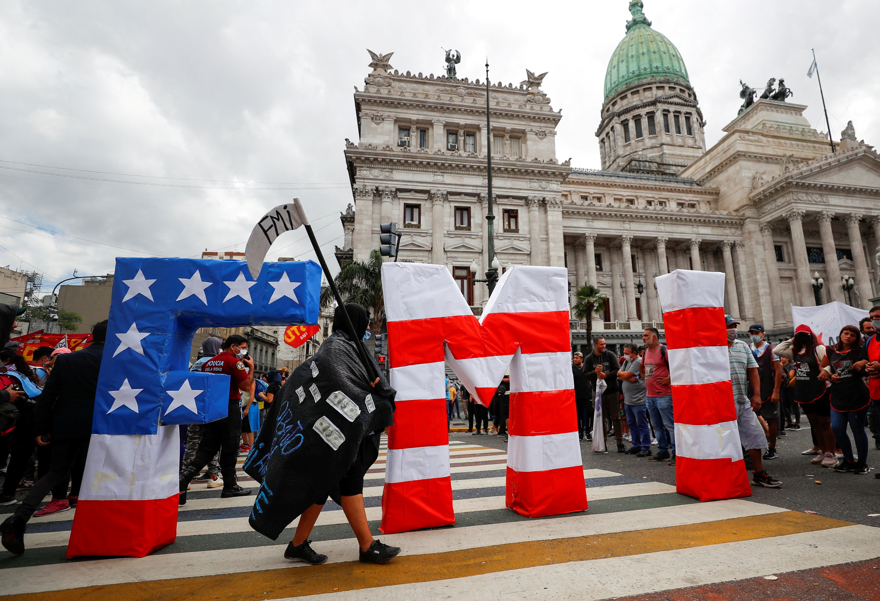 FILE PHOTO: A demonstrator wearing a costume takes part in a protest outside the National Congress, as members of the parliament debate the government's agreement with the International Monetary Fund (IMF), in Buenos Aires, Argentina March 10, 2022. REUTERS/Agustin Marcarian/File Photo