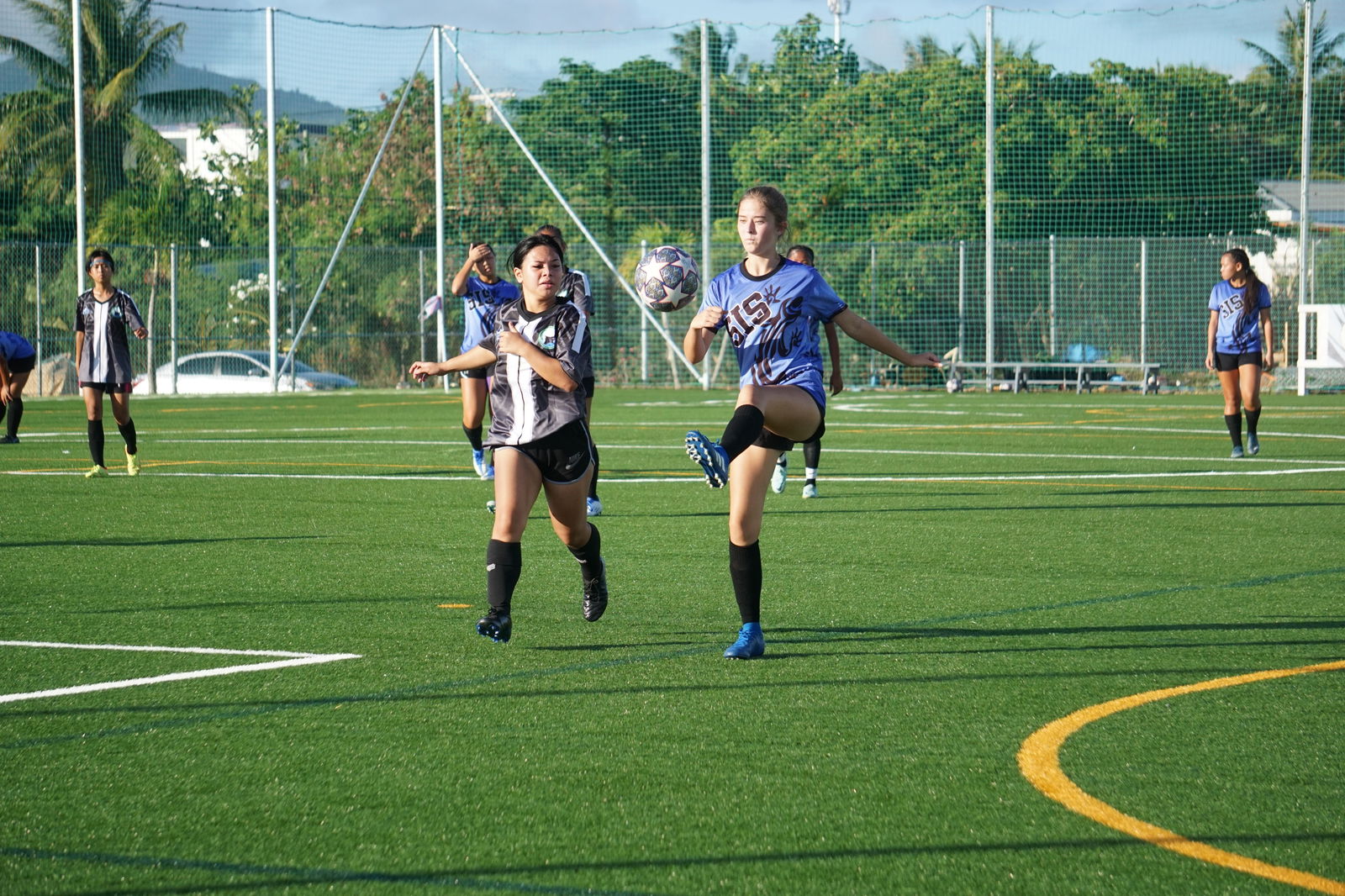 Saipan International School's Mimi Culp extends to control the possession as a Saipan Southern High School defender closes in during a girls high school division semifinal match of the NMIFA-PSS Interscholastic Soccer League on Tuesday at the NMI Soccer Training Center in Koblerville.