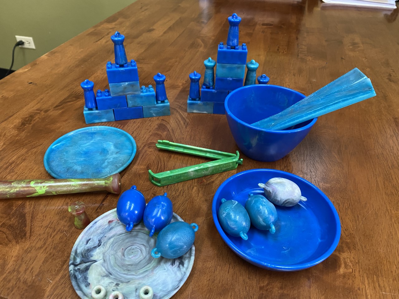 All products displayed here were made with plastics upcycled on Saipan. Note a ruler, bowl, latte stone jewelry and more.