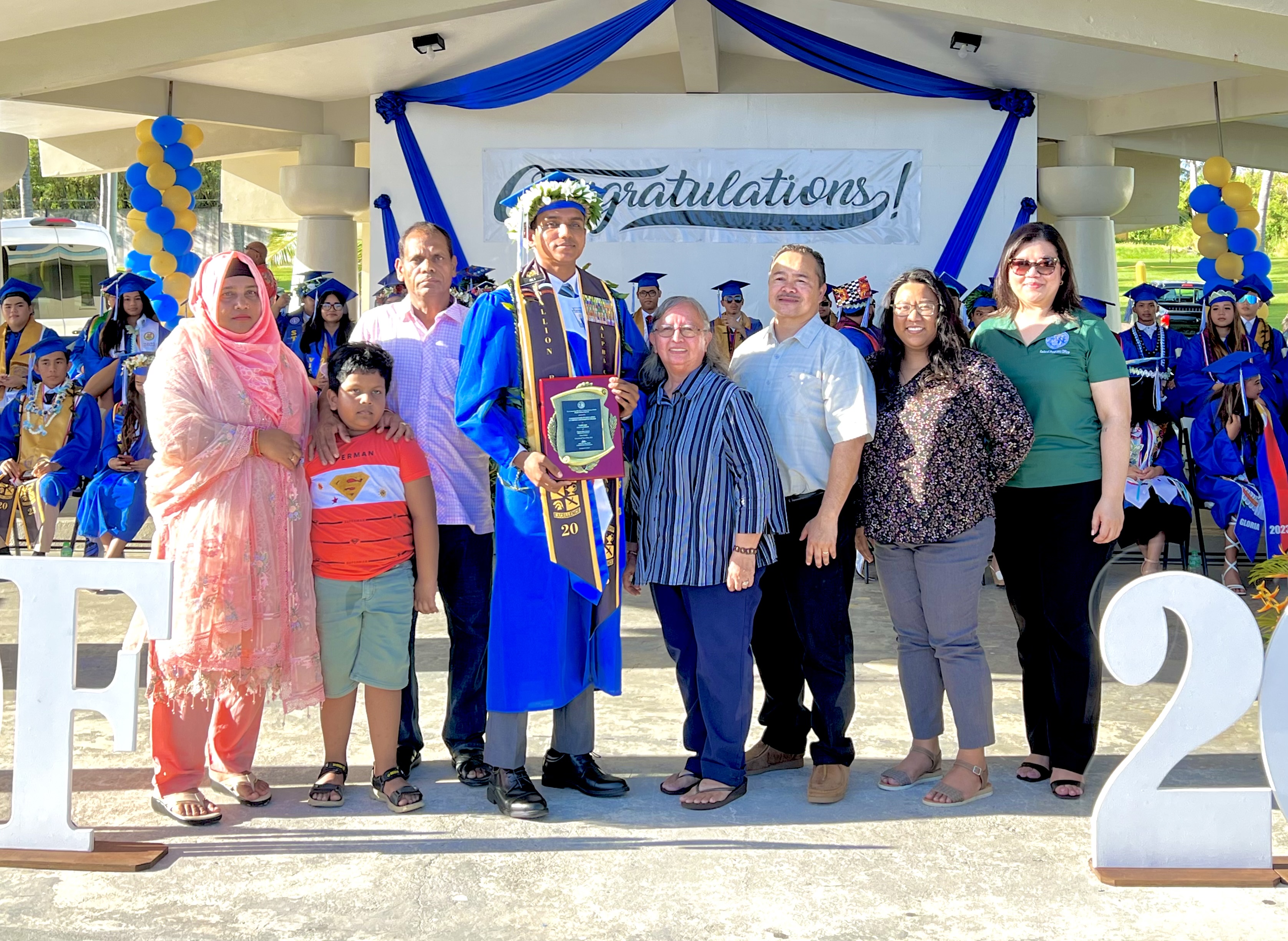 Class of 2023 Salutatorian Saim Ali, with his parents, brother and grandma Daria Cing, receives the Commissioner of Education Academic Excellence Award from Dr. Alfred B. Ada. Also in photo are Interim Federal Programs Officer Jacqueline Che and Interim Instructional Technology and Distance Education Program Director Lorraine Catienza. Ali is also the recipient of the Mayor’s Award.