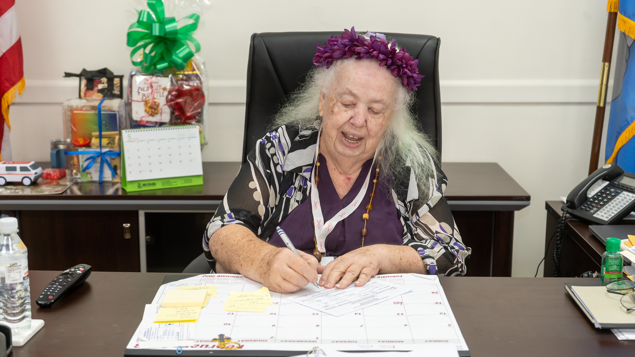Honorary Lt. Governor Genia Draper signs a document during the Manamko' Takeover Day at the Office of the Governor.