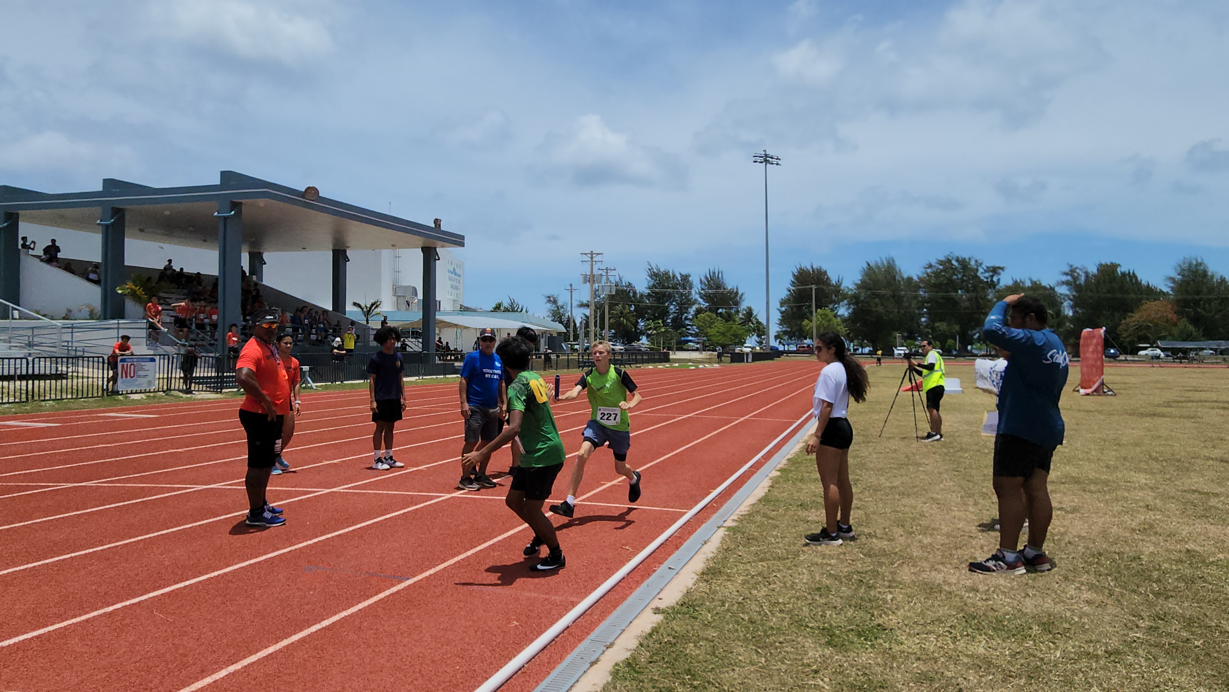A Dandan Middle School student passes the baton to a teammate during the U14 4x100M relay event of the PSS-McDonald's All School Athletics Championships on Saturday at the Oleai Sports Complex.