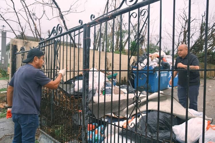 Mongmong-Toto-Maite Mayor Rudy Paco, left, has a dispute with an employee of Palm Breeze Apartments about trash disposal at the complex Tuesday, May 30, 2023. 