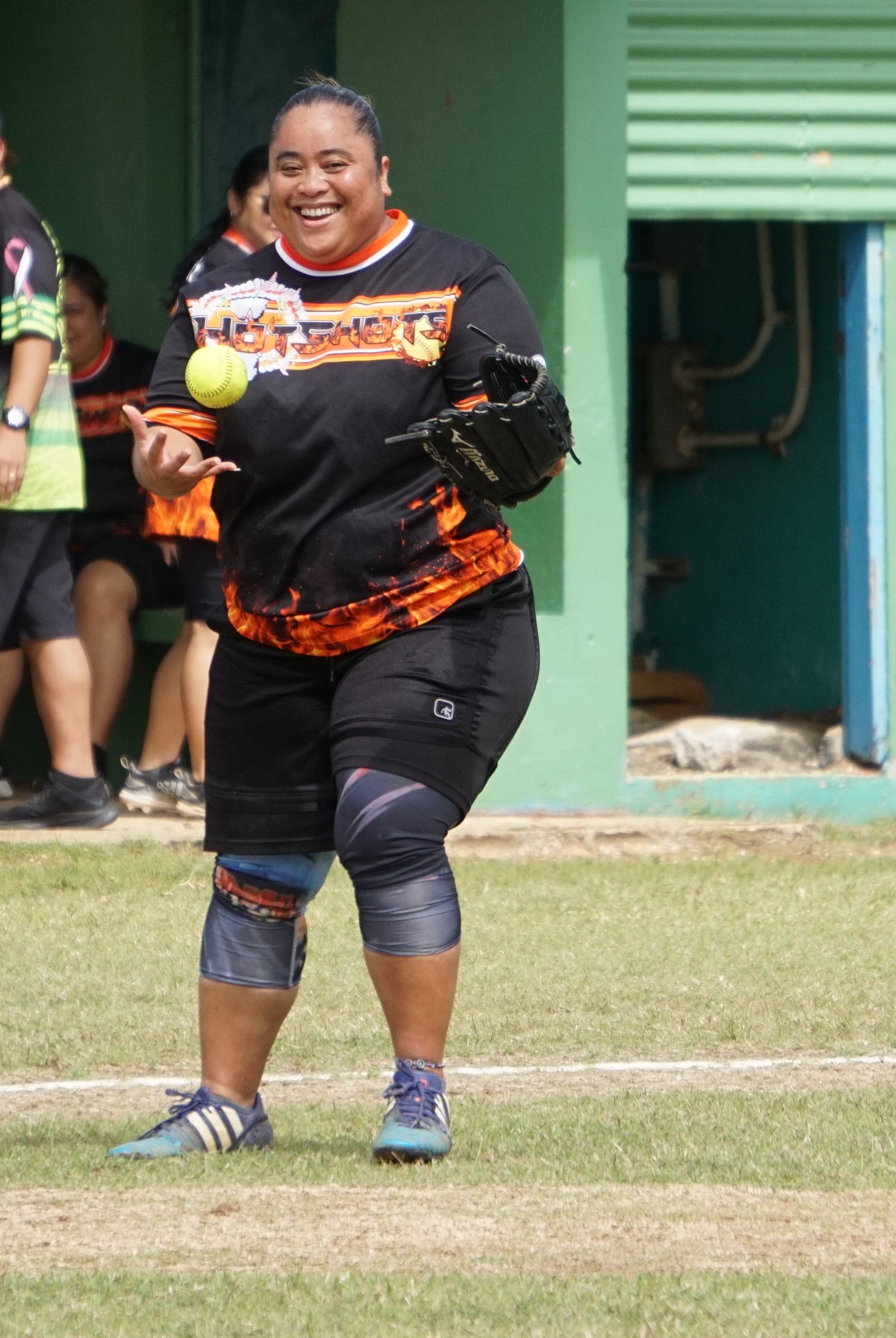 Janice Celis of the Hotshots smiles after recovering a grounder during a ladies division game of the 2023 Budweiser Belau Amateur Softball League at the Dandan baseball field.