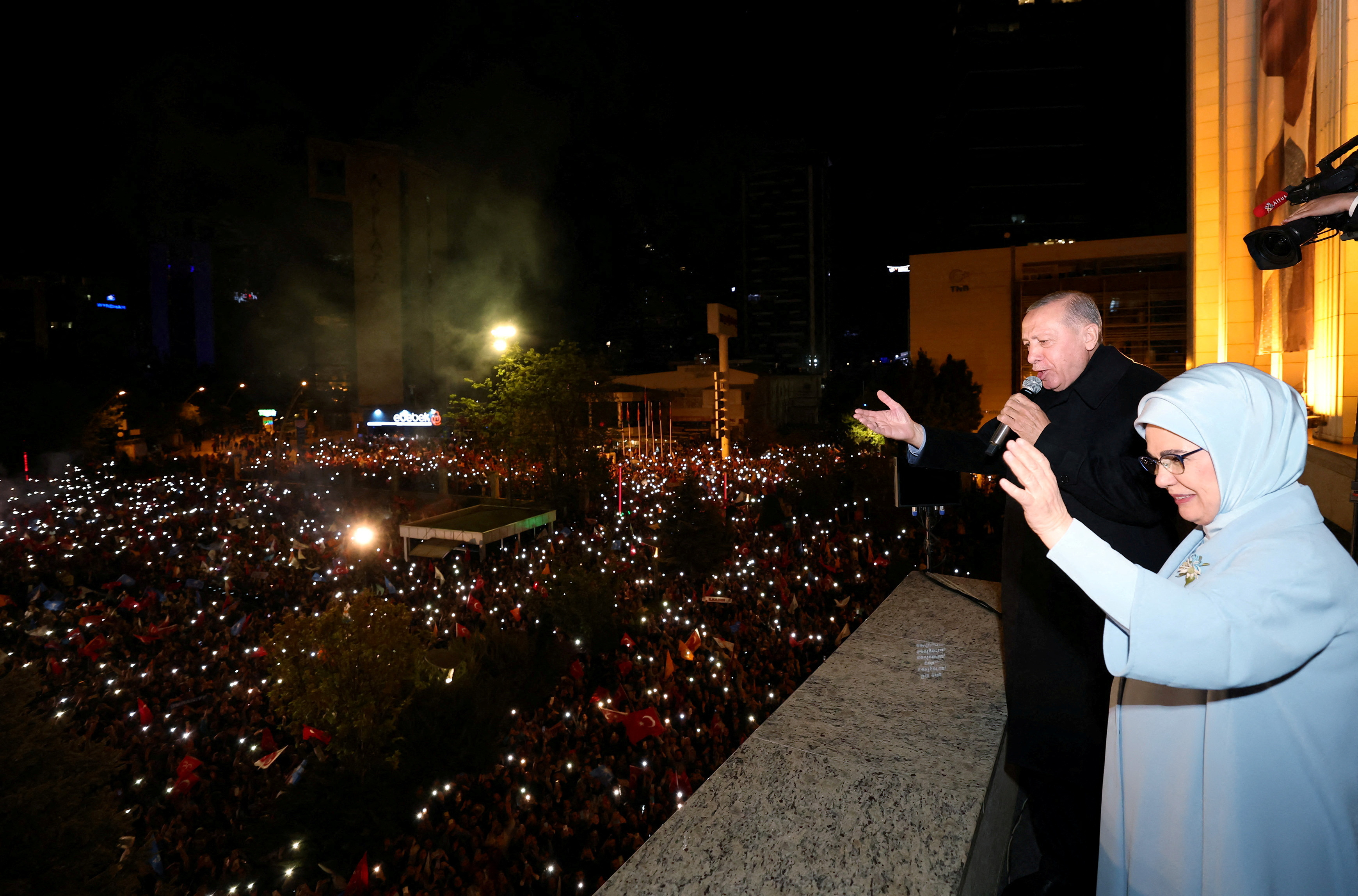Turkish President Tayyip Erdogan, accompanied by his wife Emine Erdogan, addresses his supporters at the AK Party headquarters in Ankara, Turkey May 15, 2023. Presidential Press Office/Handout via REUTERS