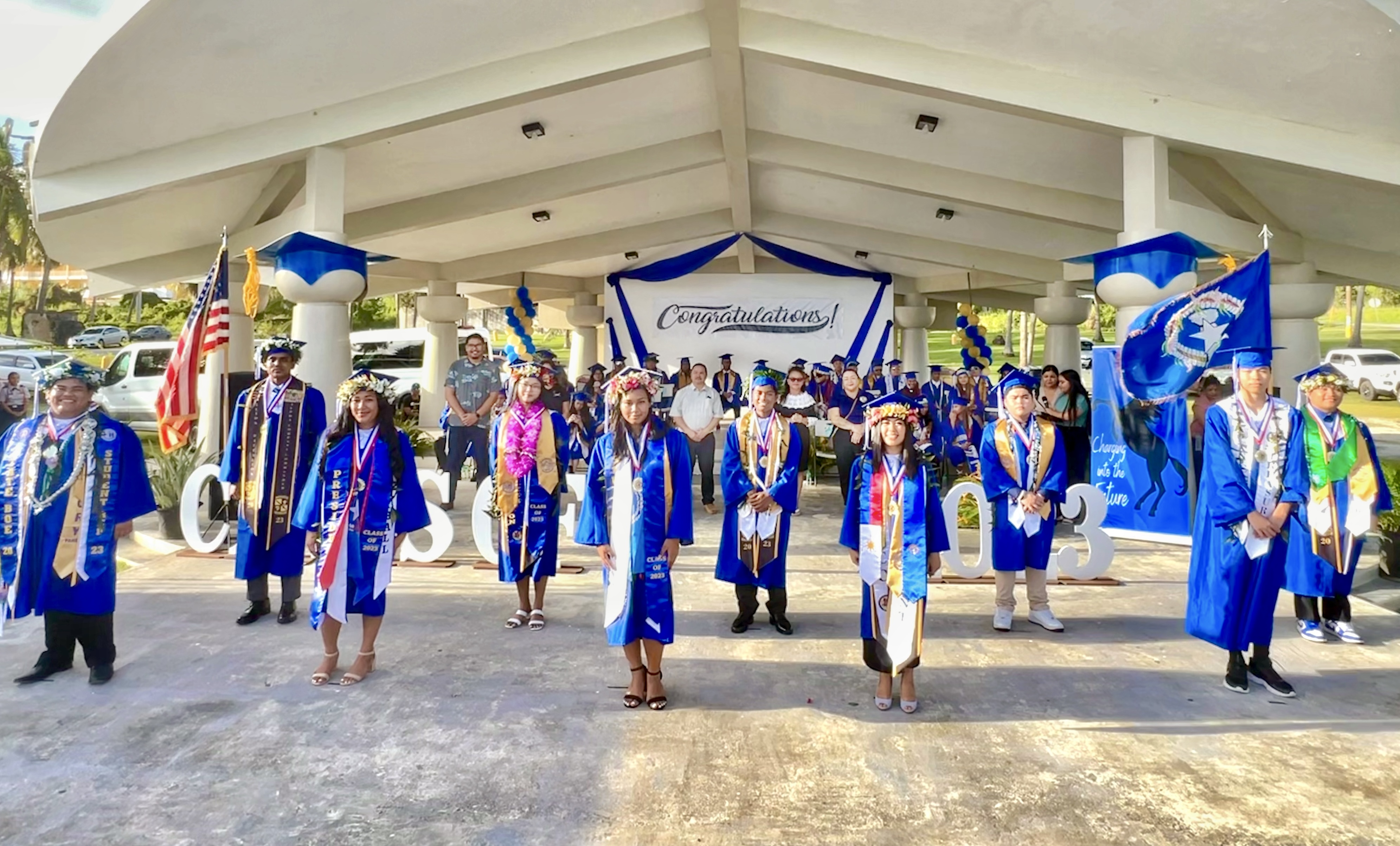 The top 10 graduates of Tinian High School: (10) Gio Palmitos Vergara; (9) Jun Jie Luo; (8) Christian Carlo Libut Sanchez); (7) Chad Andrei Llanora Acollador; (6) Ismail Imran Veri Hossain; (5) Guillermina Rose Cruz San Nicolas; (4) Hazel Anne Pablo Mabansag; (3) Isa Liana King Reyes; (2) salutatorian Saim Ali; and (1) valedictorian Ryan Micahel Achacoso Nuera are introduced to the public during their commencement program on Saturday. In the background are Board of Education Chairman Antonio L. Borja, BOE Member Maisie B. Tenorio, Commissioner of Education Dr. Aflred B. Ada, Interim Federal Programs Officer Jacqueline Che, Interim Instructional Technology & Distance Education Program Director Lorraine Catienza, THS Principal Liz Perzinski and Vice Principal Nikita Mendiola.
