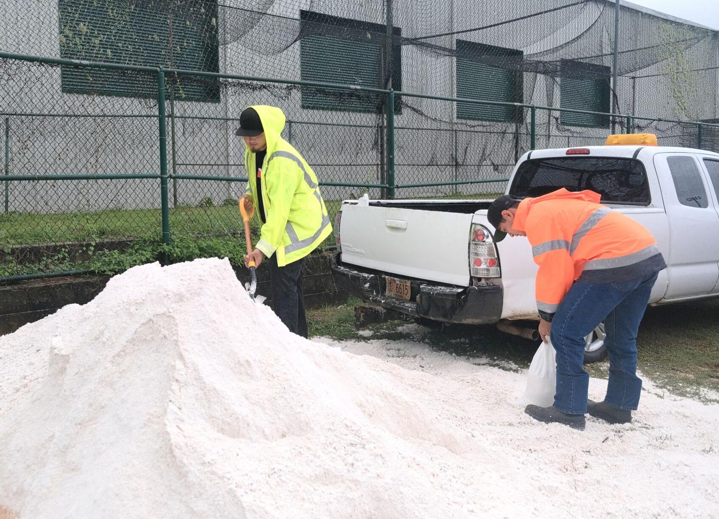 Sinajana Mayor's Office employee Auron Eclavea, right, and his brother David Eclavea, an Agana Heights Mayor's Office employee, prepare bags of sand for residents in preparation ahead Supertyphoon Mawar at the Agana Heights Baseball Field on Tuesday. 