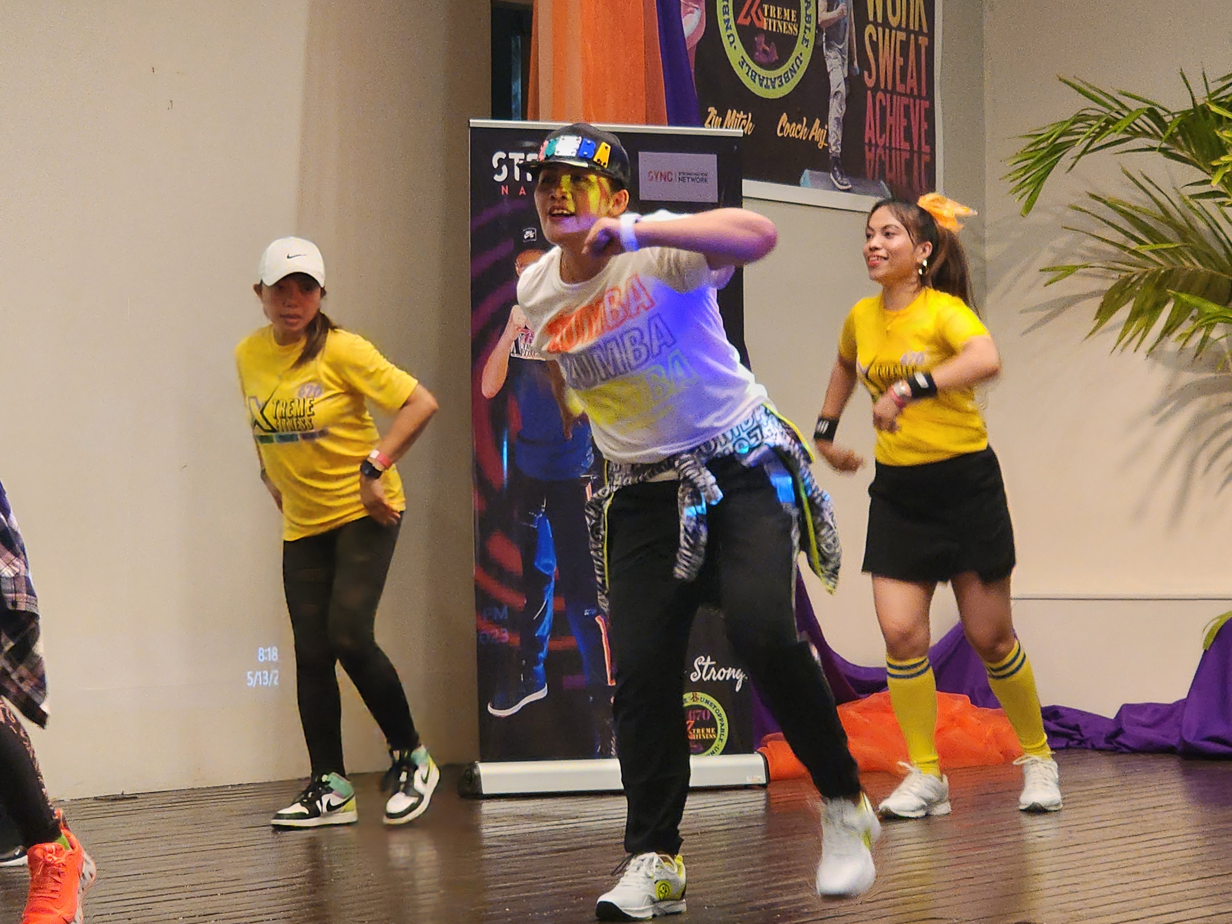 Xtreme Fitness670 instructor Mitch Olita, center, leads a Zumba dance workout during the organization’s first anniversary celebration on Saturday at the Hibiscus Hall of Crowne Plaza.