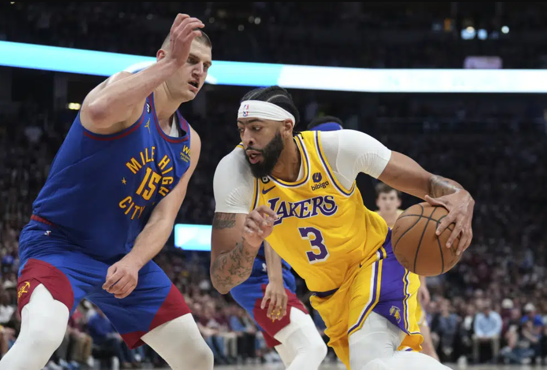 Los Angeles Lakers forward Anthony Davis (3) drives on Denver Nuggets center Nikola Jokic (15) during the first half of Game 1 of the NBA basketball Western Conference Finals series, Tuesday, May 16, 2023, in Denver.