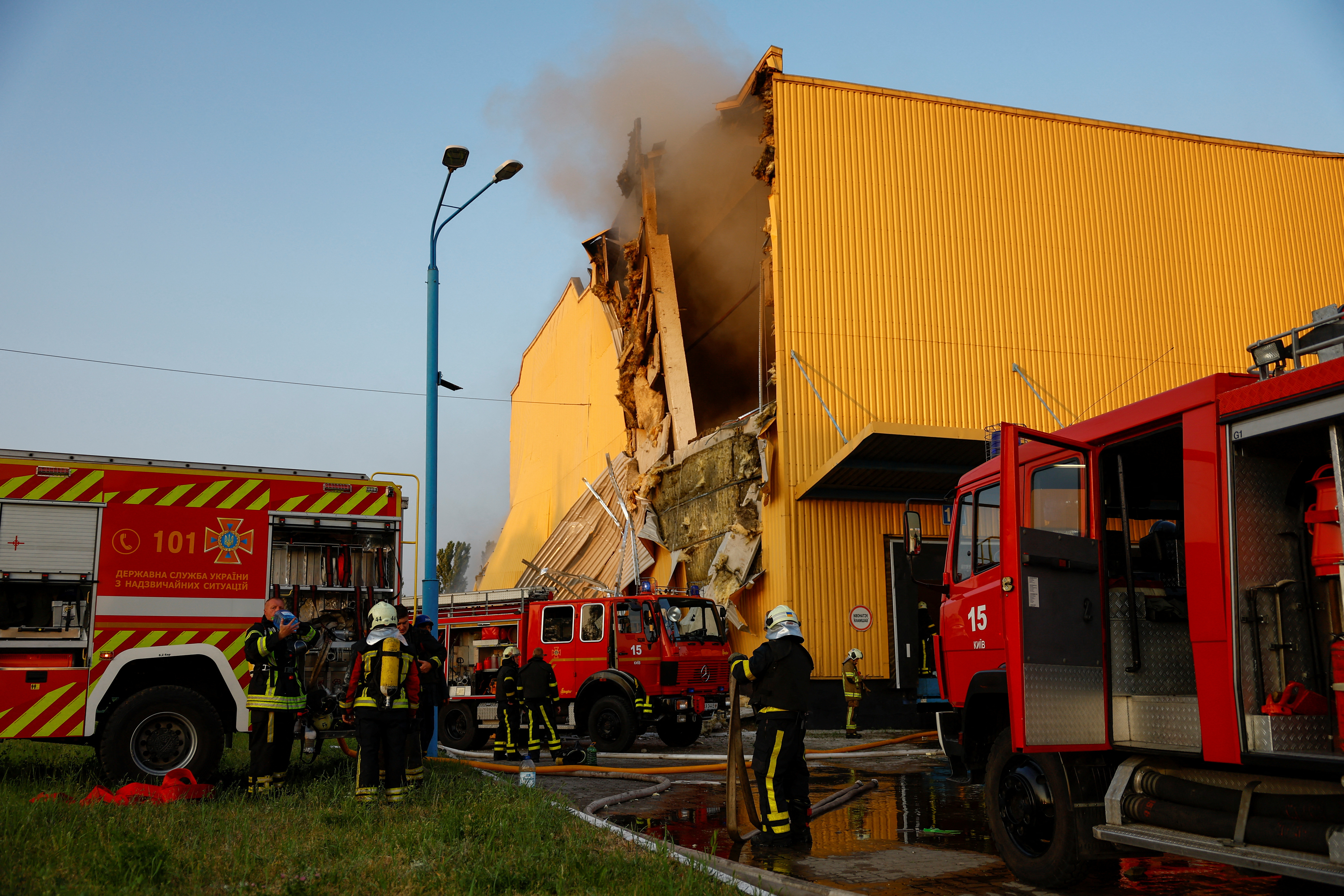 Firefighters work at a site of a tobacco factory damaged during Russian suicide drone strike, amid Russia's attack on Ukraine, in Kyiv, Ukraine May 28, 2023. REUTERS/Valentyn Ogirenko.
