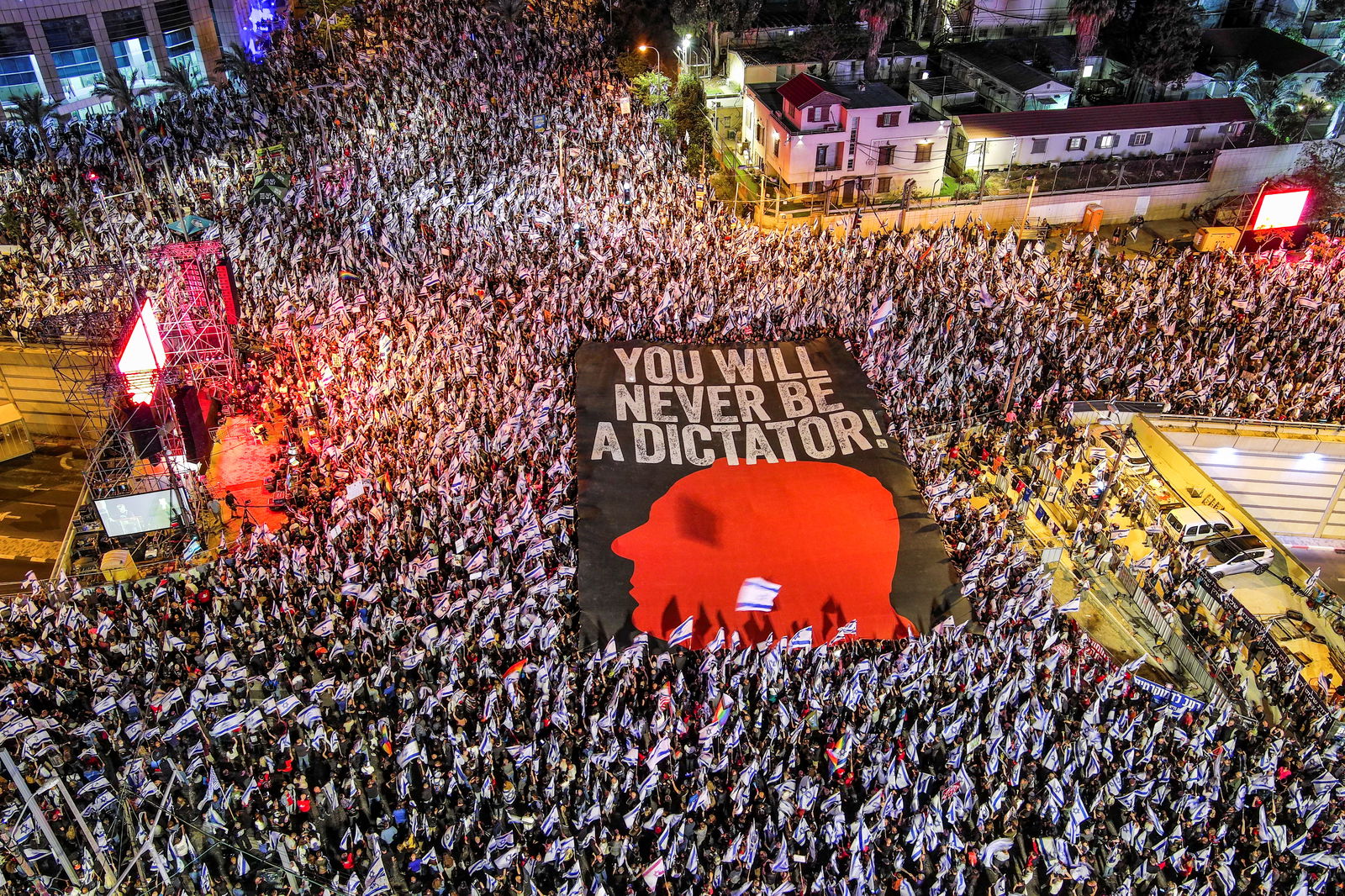 An aerial view shows protesters holding a sign with the silhouette of the face of Israeli Prime Minister Benjamin Netanyahu, as they take part in a demonstration against Israel's nationalist coalition government's judicial overhaul, in Tel Aviv, Israel May 6, 2023. REUTERS/Ilan Rosenberg