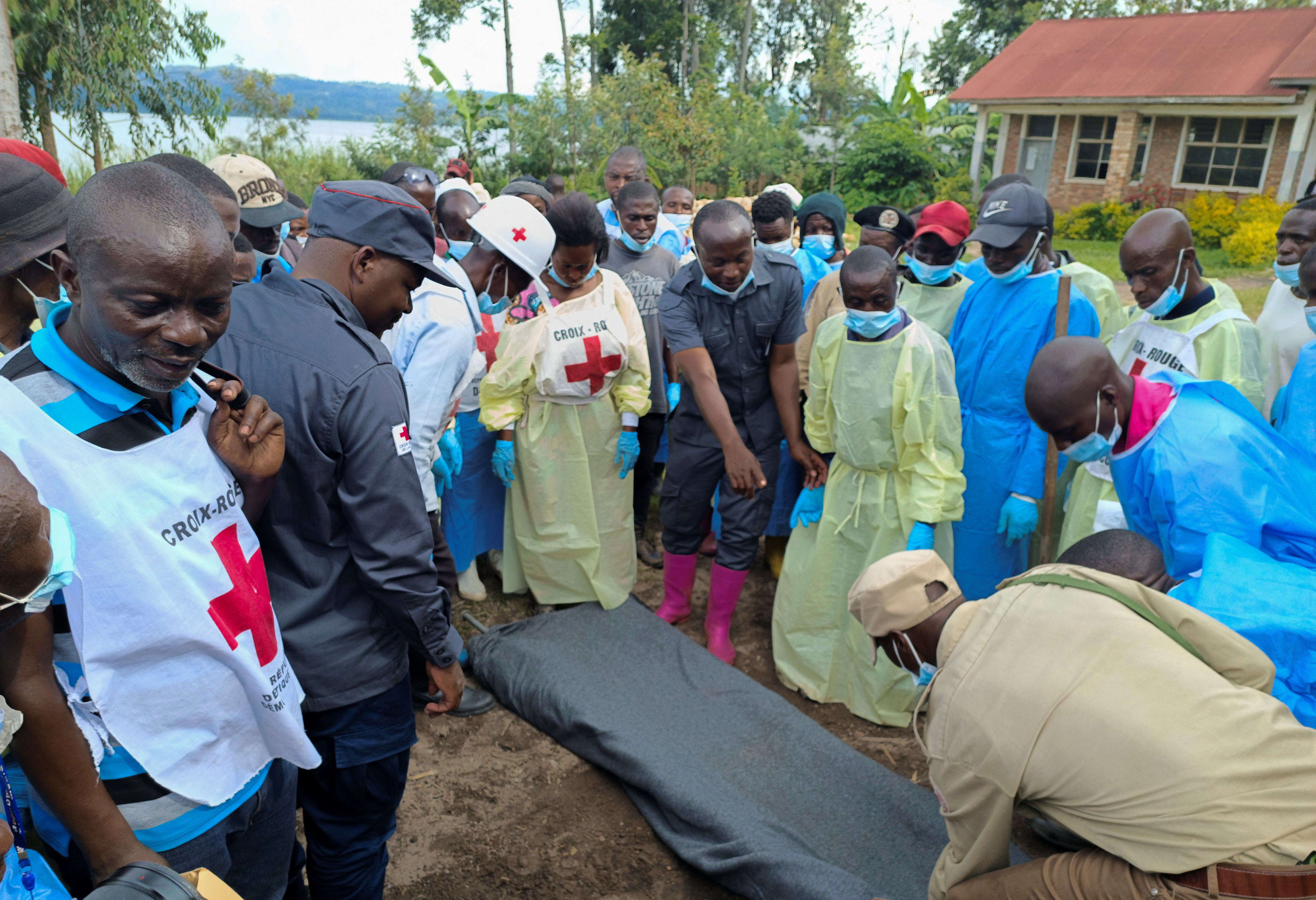 Red Cross workers and volunteers gather for a briefing where Congolese civilians were killed following rains that destroyed the remote, mountainous area and ripped through the riverside villages of Nyamukubi, Kalehe territory in South Kivu province of the Democratic Republic of Congo May 9, 2023. REUTERS/Djaffar Sabiti