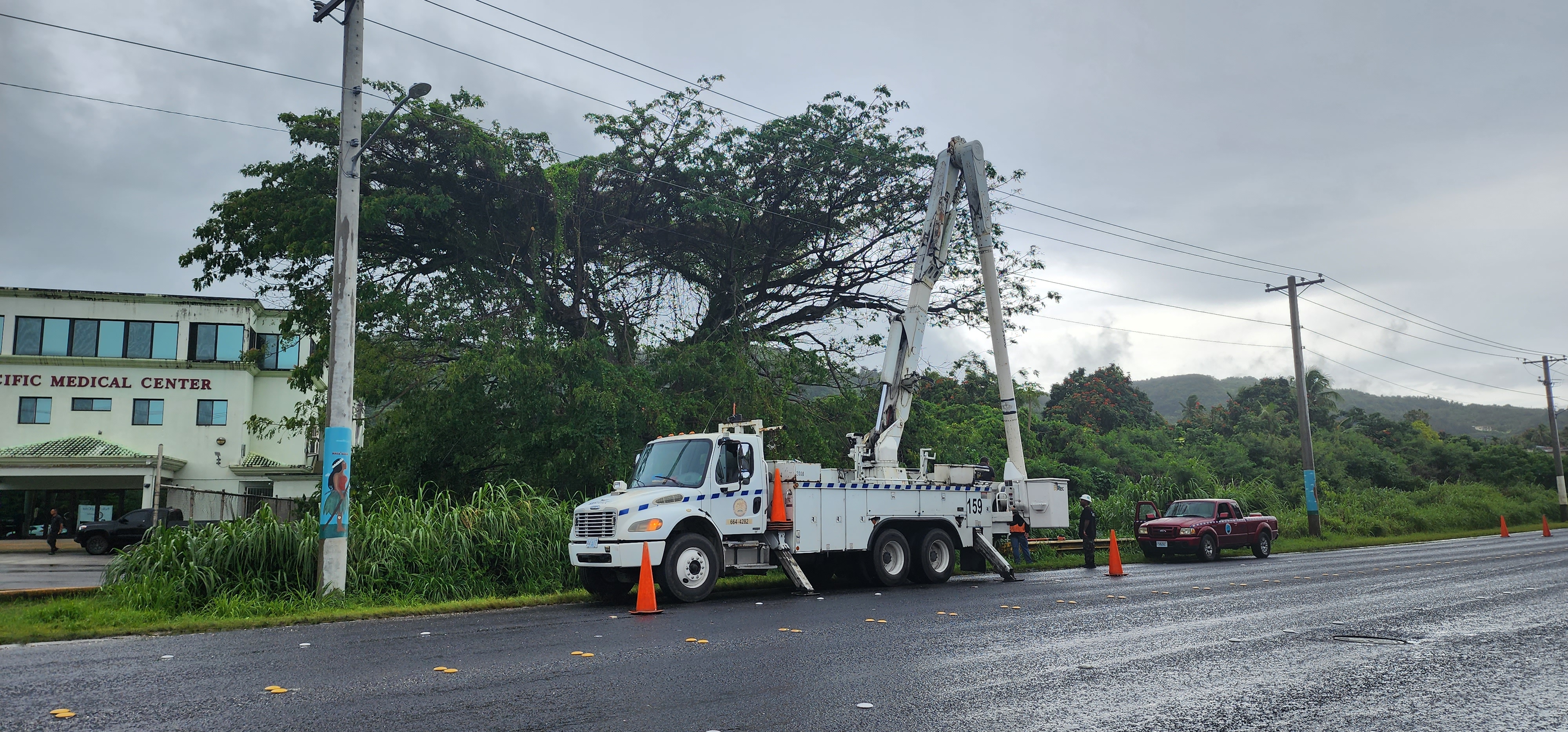 Commonwealth Utilities Corp. crewmembers check the power lines on Middle Road in Garapan, Tuesday.