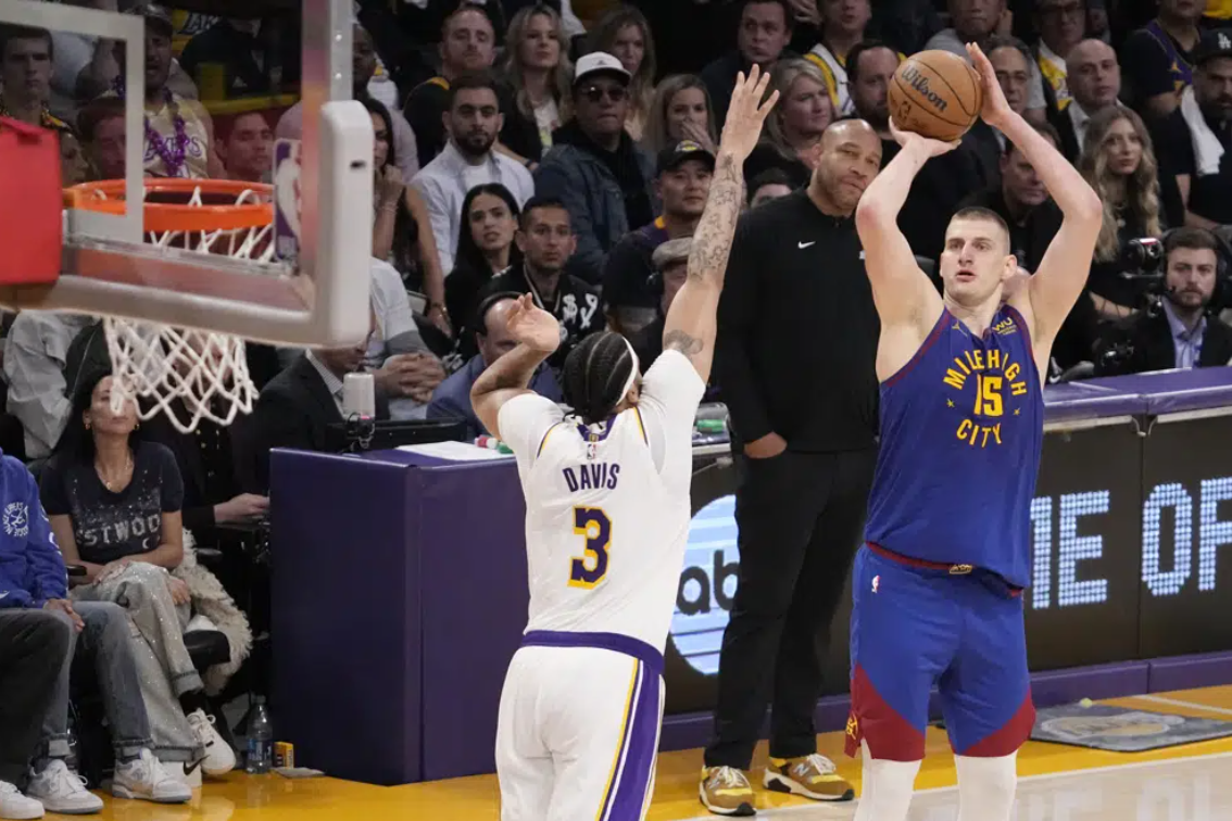 Denver Nuggets center Nikola Jokic (15) shoots over Los Angeles Lakers forward Anthony Davis (3) in the second half of Game 3 of the NBA basketball Western Conference Final series Saturday, May 20, 2023, in Los Angeles.