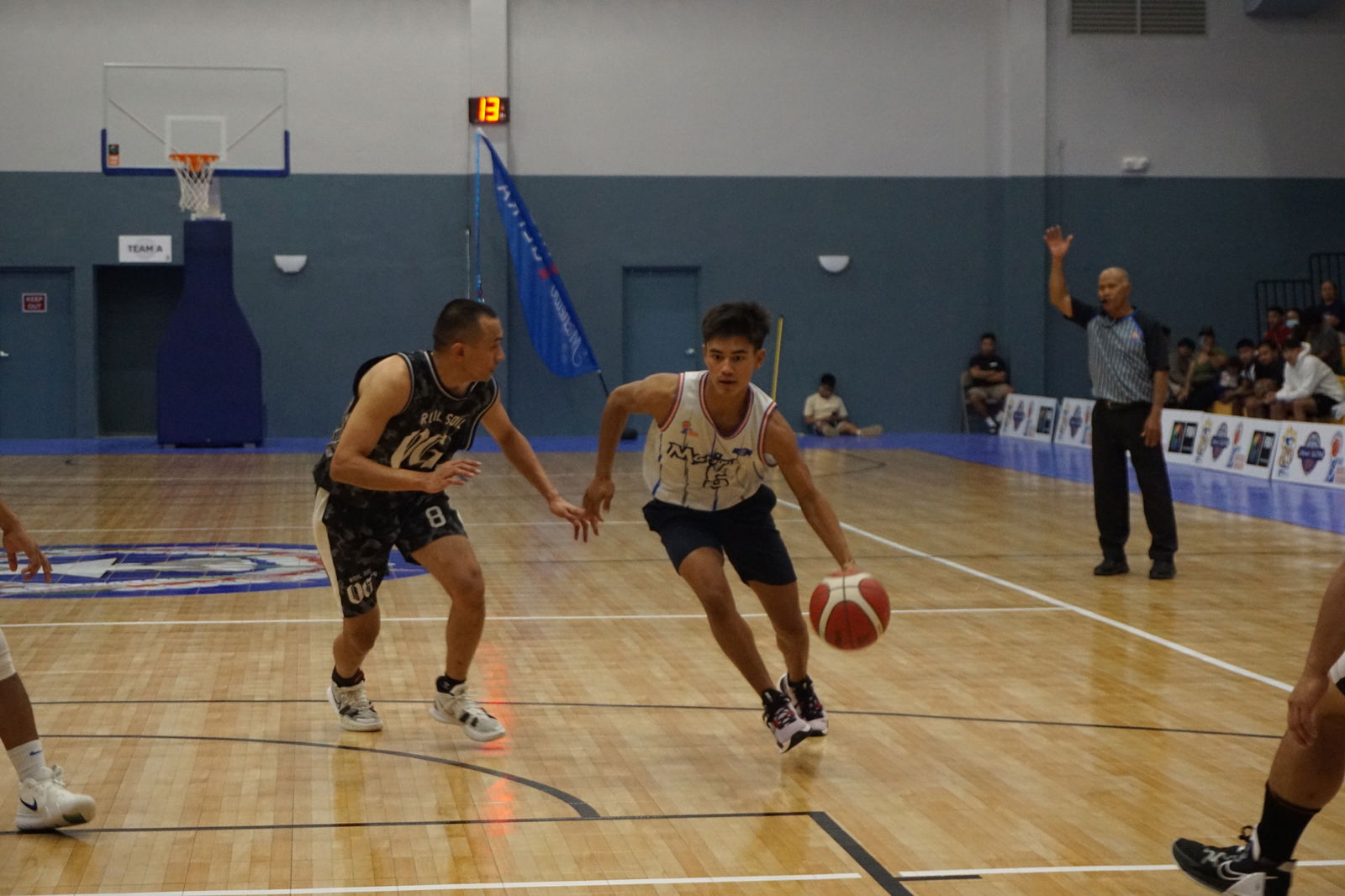 Team Marianas' Matthew Richardson attempts to dribble past Roil Soil OG's Sid Quan in a Michelob Ultra Cup game at the Ada gym.