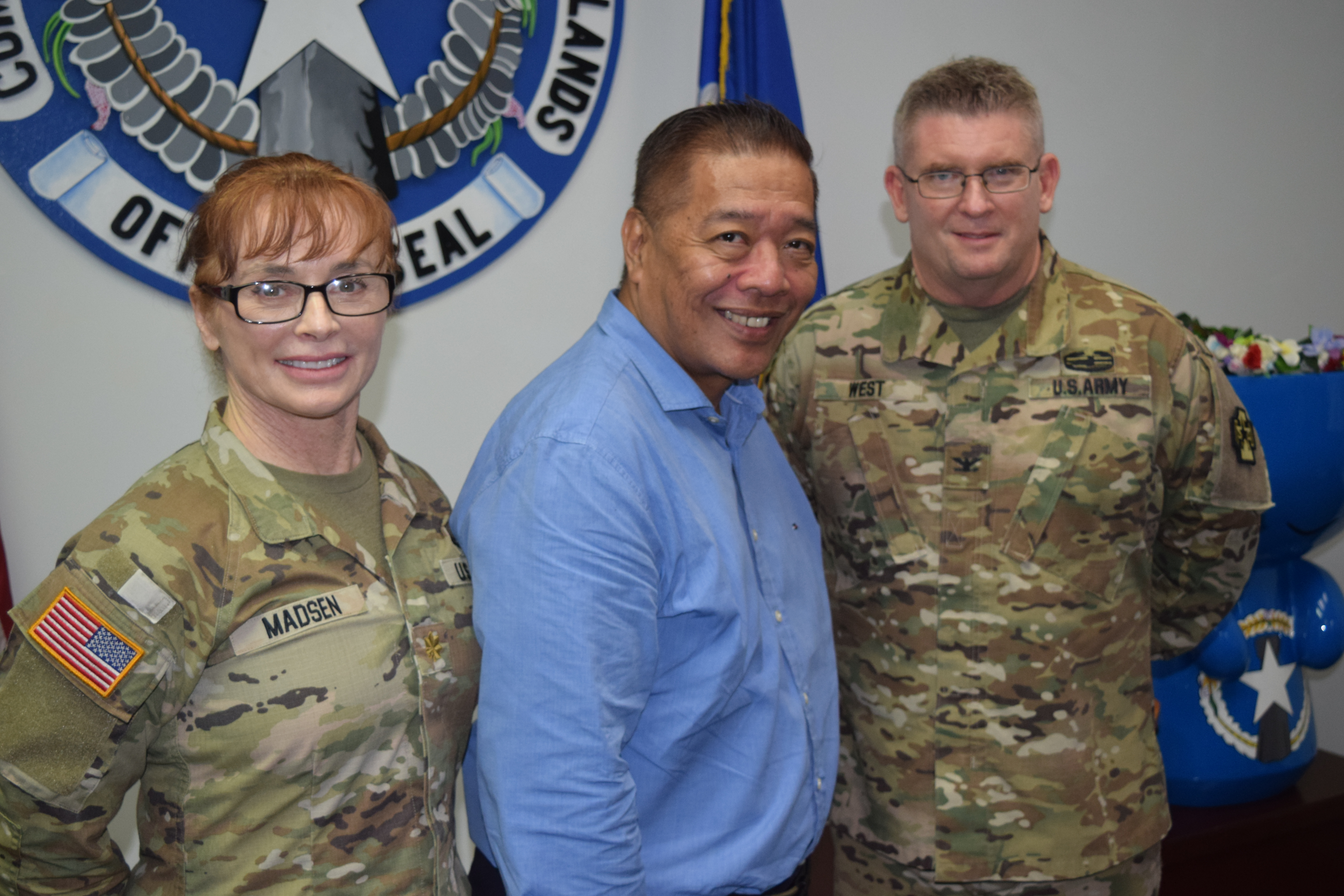 From left, CNMI Wellness Mission Project Manager Maj. Samantha Madsen, Special Assistant to the Governor for Military Affairs Danny Aquino and  CNMI Wellness Mission Commander Col. Hugh West pose for a photo during a press conference at the administration building on Thursday.