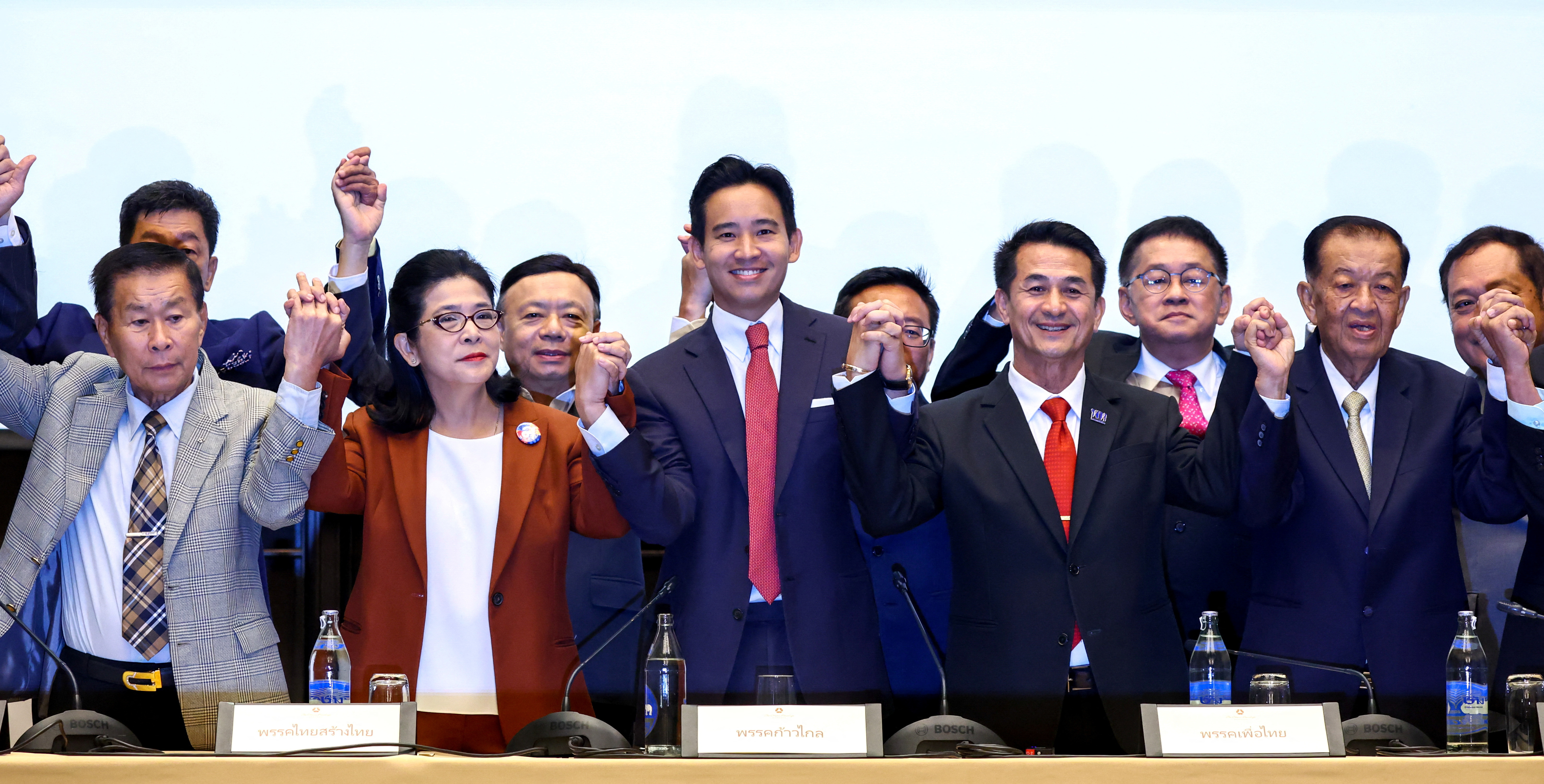 Move Forward Party leader Pita Limjaroenrat holds hands with coalition party leaders following a meeting with coalition partners in Bangkok, Thailand, May 18, 2023. REUTERS/Athit Perawongmetha