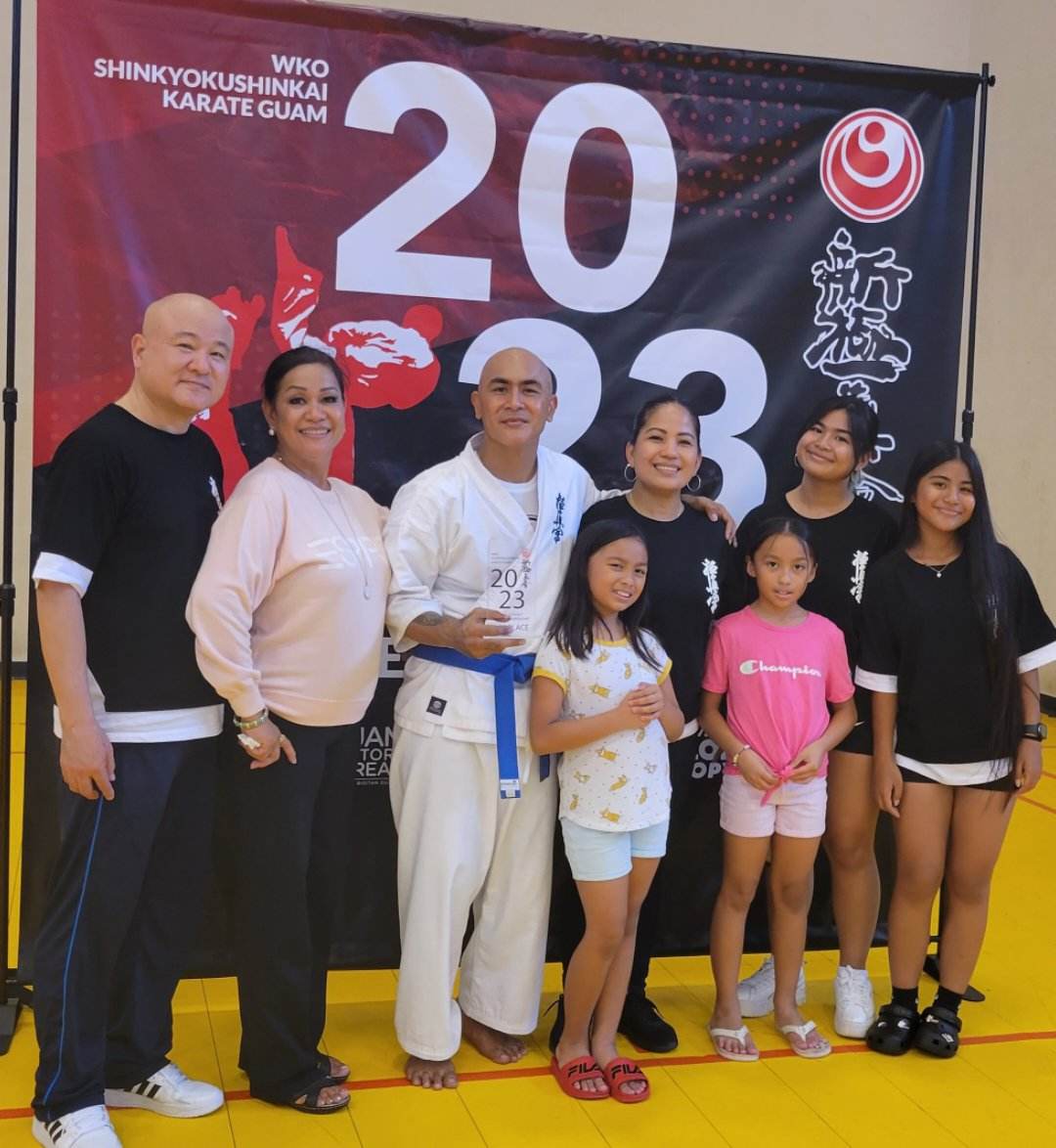 Jerry Diaz poses with his family and entourage after winning the WKO Shinkyokushinkai Guam Full Contact Karate Championship at the Ilearn Academy Gymnasium on Guam.