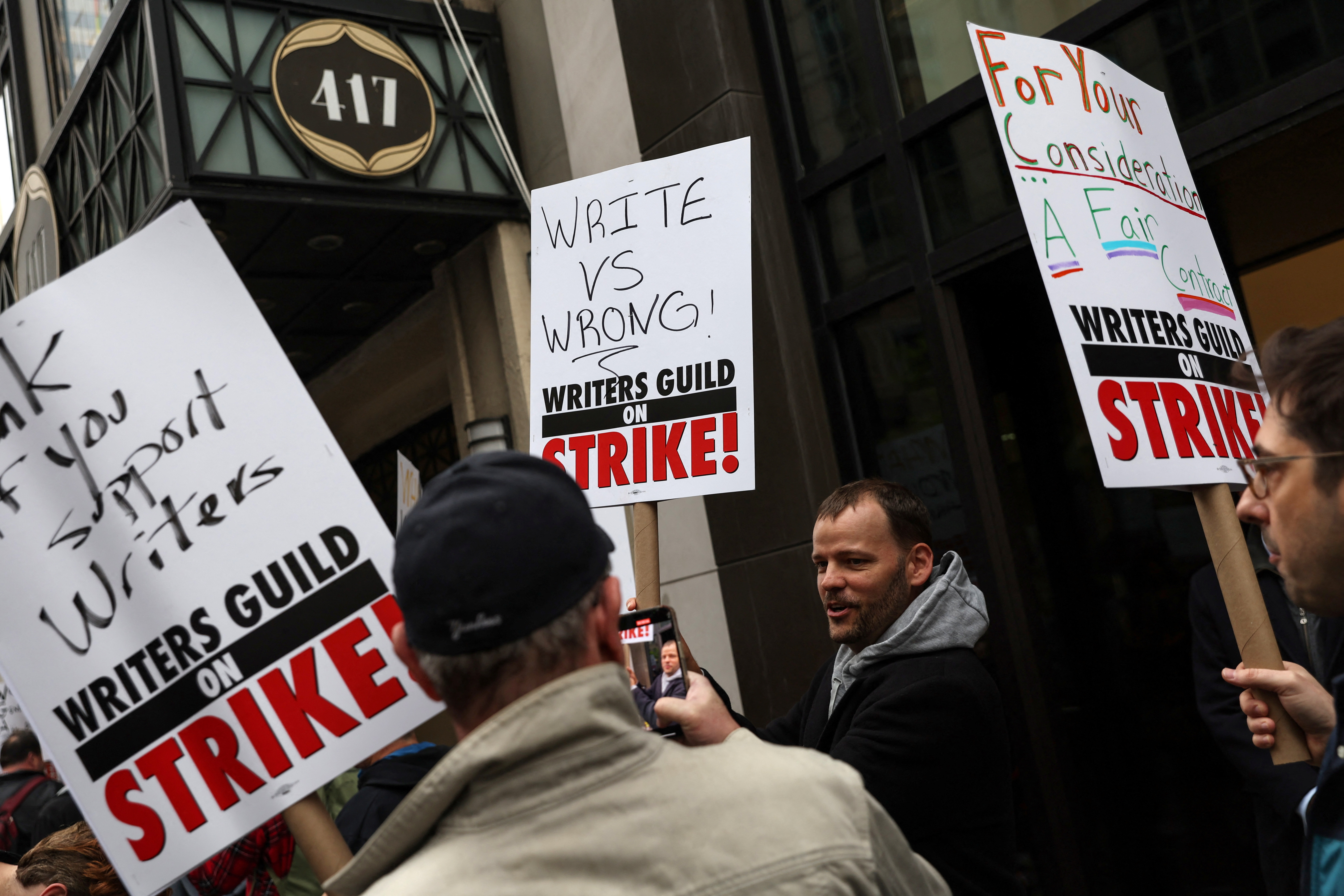 Members of the Writers Guild of America (WGA) East picket outside Peacock Newfront streaming service offices, in New York City, U.S., May 2, 2023. REUTERS/Shannon Stapleton