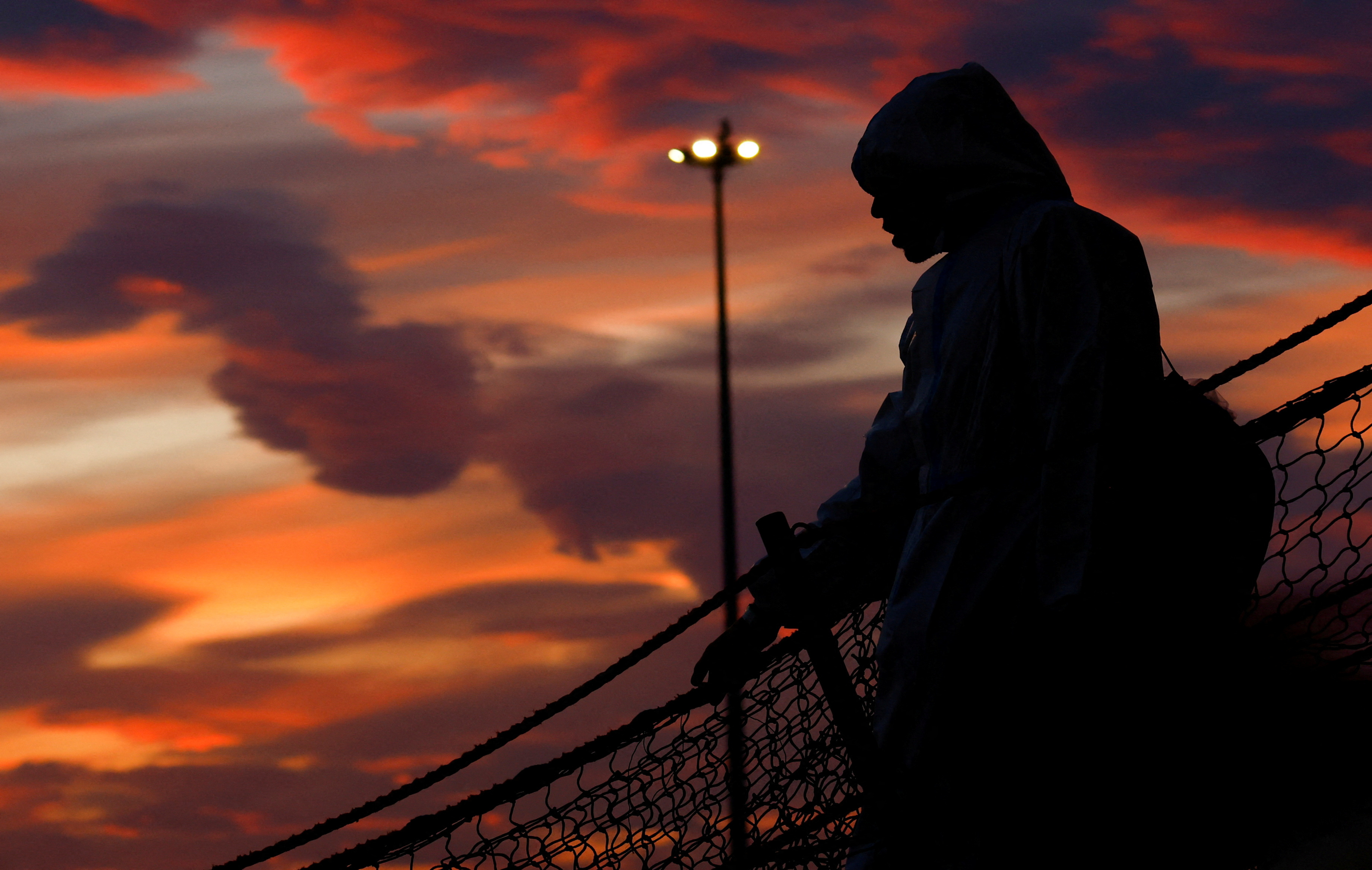 FILE PHOTO: A person disembarks the Geo Barents rescue ship, operated by Medecins Sans Frontieres (Doctors Without Borders), in Bari, Italy March 26, 2023. REUTERS/Darrin Zammit Lupi/File Photo