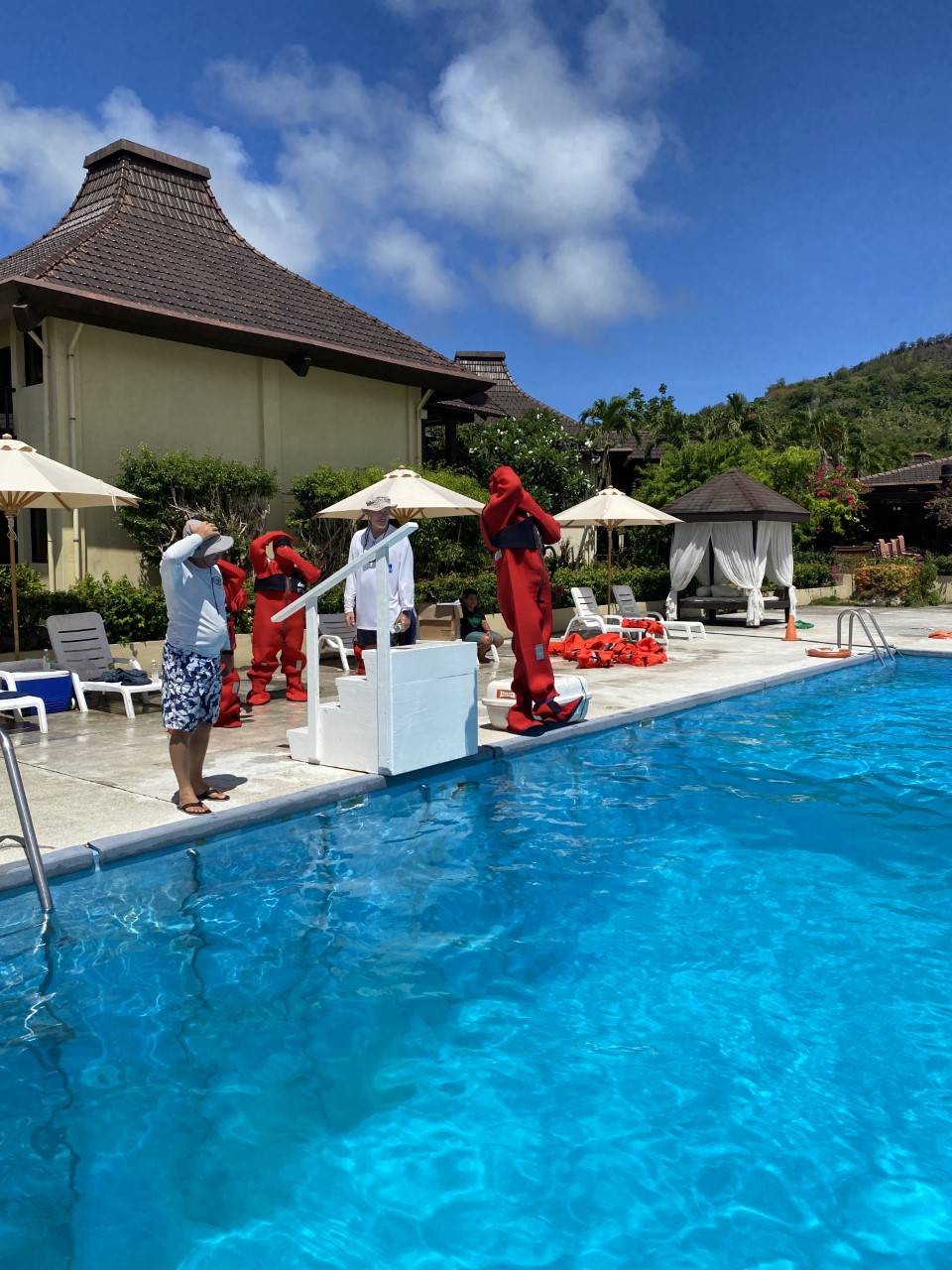 As part of personal survival training, a Kagman High School student donned an immersion suit before jumping into a pool at Aqua Resort Club.