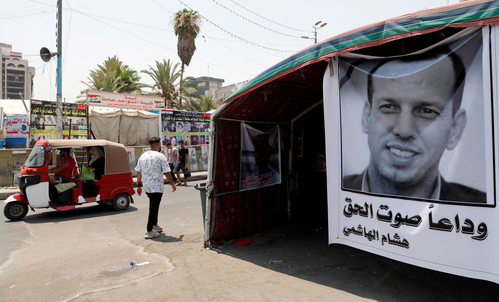 FILE PHOTO: A poster depicting the former government advisor and political analyst Hisham al-Hashemi, who was killed by gunmen is seen at the Tahrir Square in Baghdad, Iraq July 8, 2020. REUTERS/Thaier al-Sudani