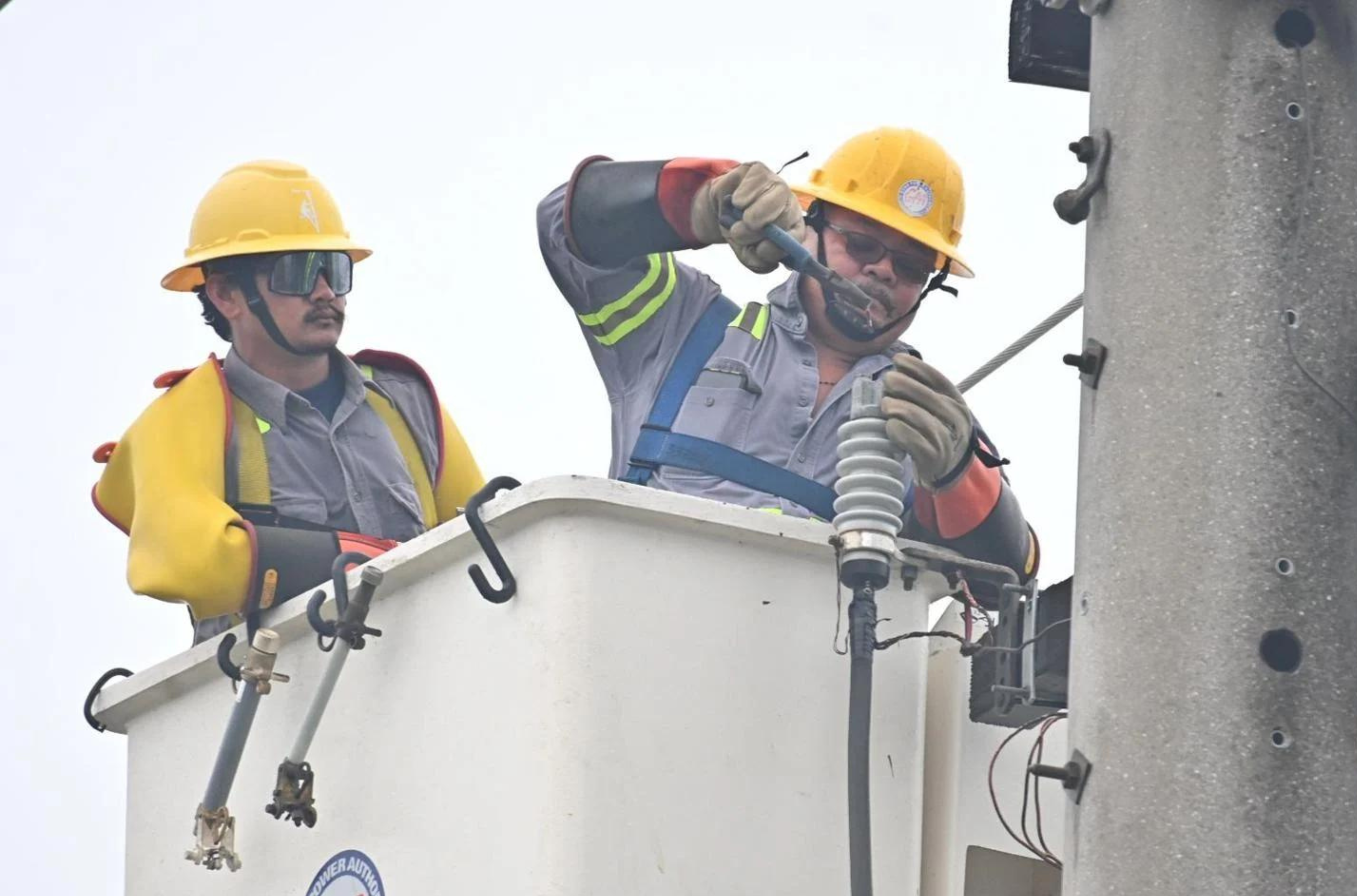 Guam Power Authority crew members work to restore power after Typhoon Mawar in Hagåtña on Thursday, May 26, 2023.