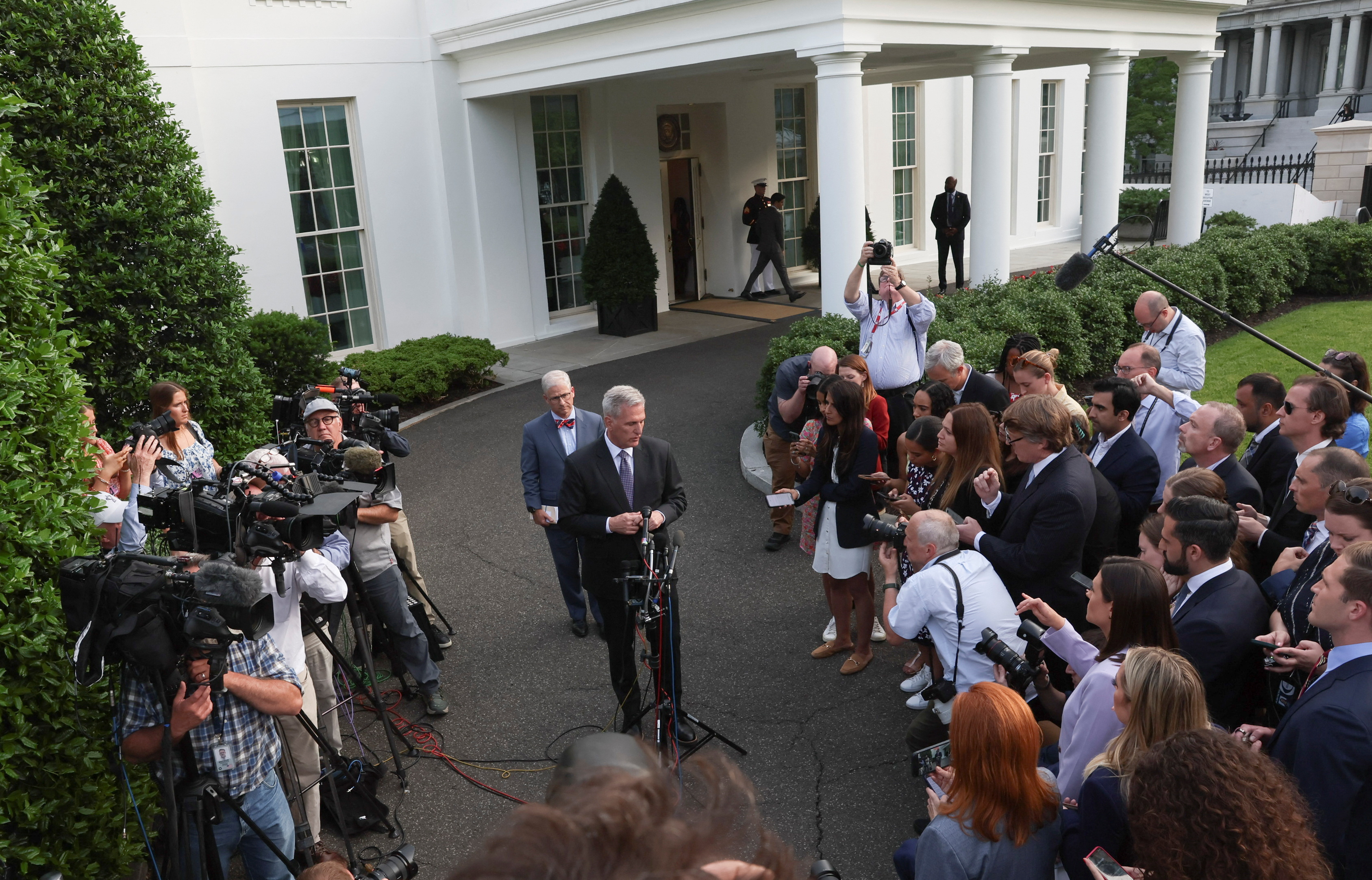 U.S. House Speaker Kevin McCarthy (R-CA) speaks to reporters outside the West Wing with Rep. Patrick McHenry (R-NC) behind him, following debt limit talks with U.S. President Joe Biden in the Oval Office of the White House in Washington, U.S., May 22, 2023. REUTERS/Leah Millis