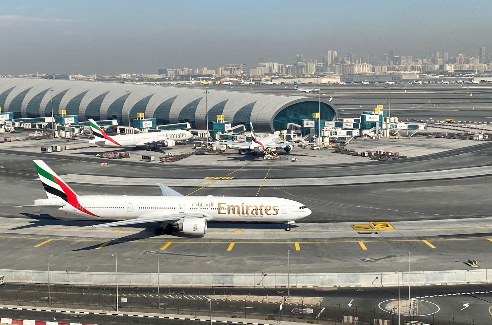 FILE PHOTO: Emirates airliners are seen on the tarmac in a general view of Dubai International Airport in Dubai, United Arab Emirates January 13, 2021. Picture taken through a window. REUTERS/Abdel Hadi Ramahi//File Photo