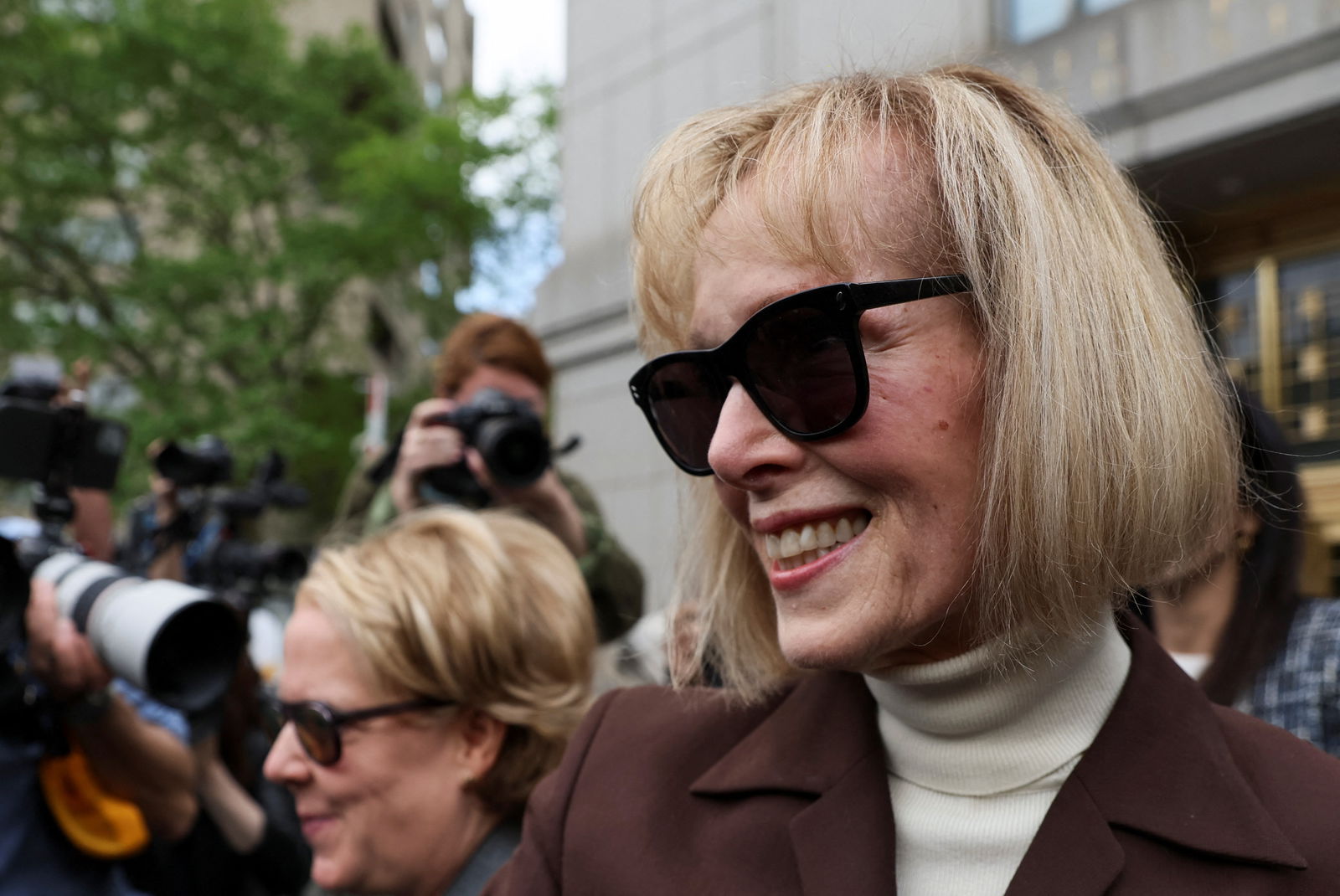 E. Jean Carroll reacts as she exits the Manhattan Federal Court following the verdict in the civil rape accusation case against former U.S. President Donald Trump, in New York City, U.S., May 9, 2023. REUTERS/Brendan McDermid