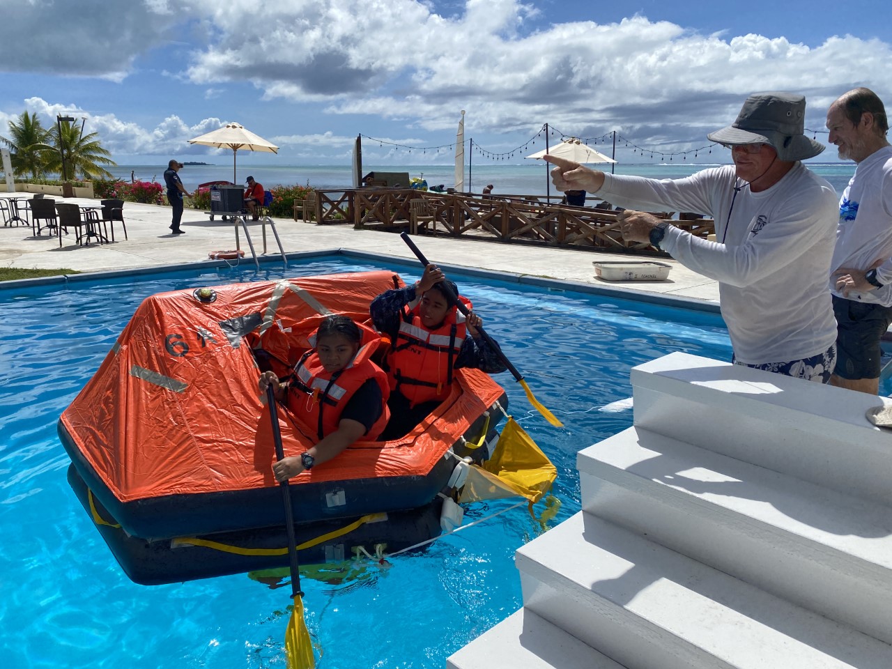 Students from Kagman High School paddle a lifeboat as part of personal survival training conducted by Captains Michael Bacher and David Johansen.