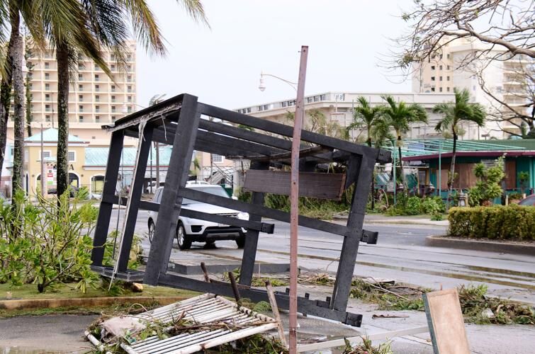TOPPLED STOP: A bus stop in Tumon was left toppled and torn up following the passage of Typhoon Mawar. John O'Connor/The Guam Daily Post 