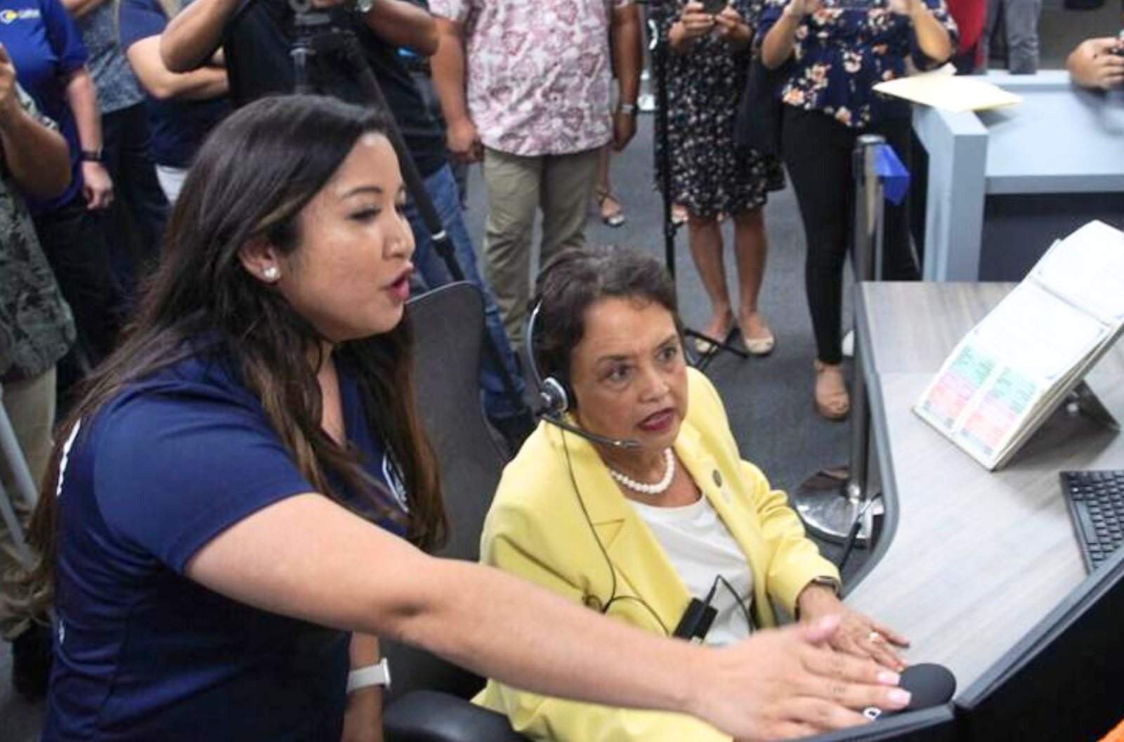 Gov. Lou Leon Guerrero, right, sits as officials help her run a mock emergency phone call to show how dispatchers operate a new 911 system, Monday, May 8, 2023, at the Guam Fire Department offices in Hagåtña.