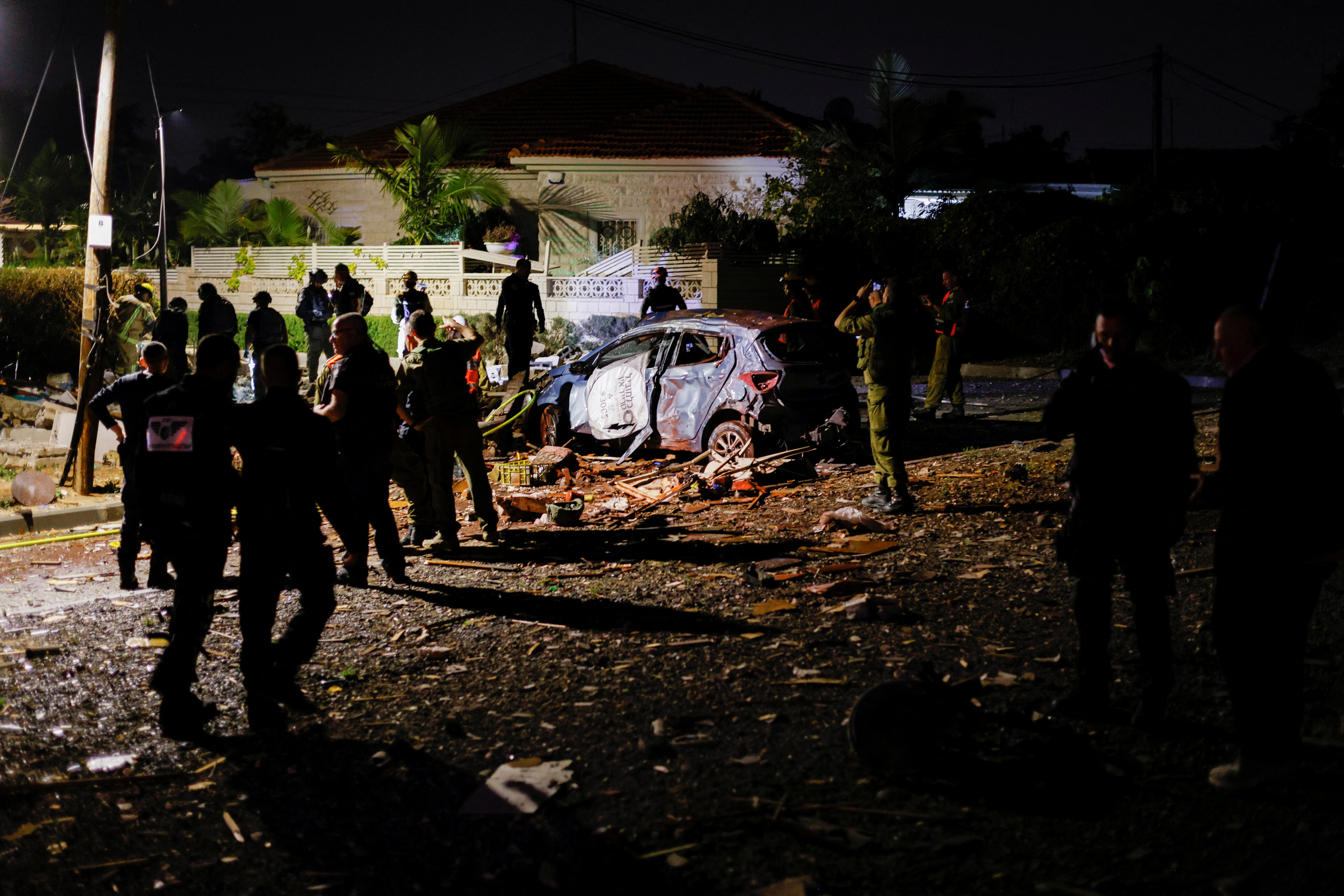 Security and rescue personnel work at the site where a rocket fired from Gaza has landed in Ashkelon, Israel May 10, 2023 REUTERS/Amir Cohen