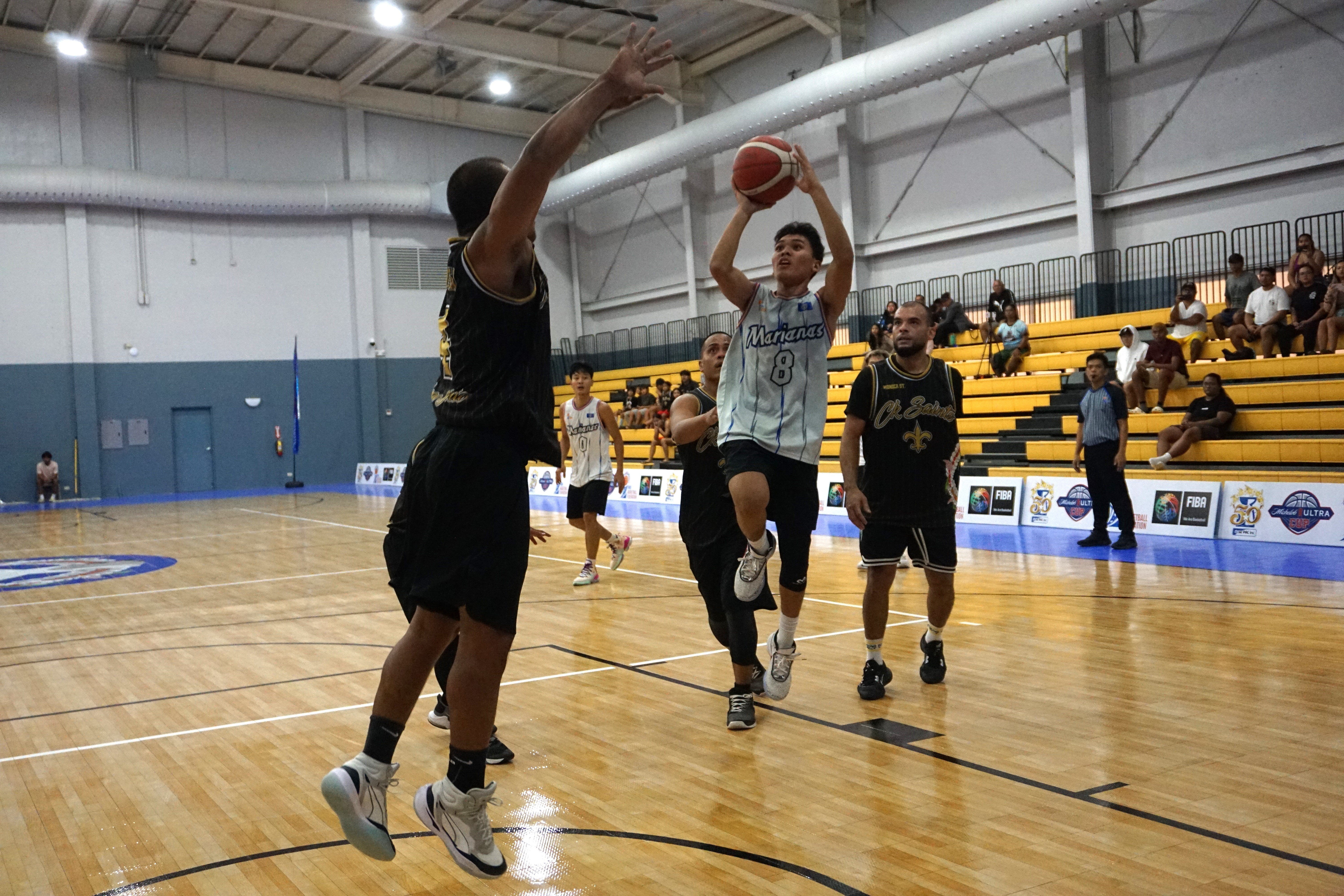 Team Marianas' Lucio Aldan attempts the floater during a playoff game of the Michelob Ultra Cup Sunday at the Ada gym.