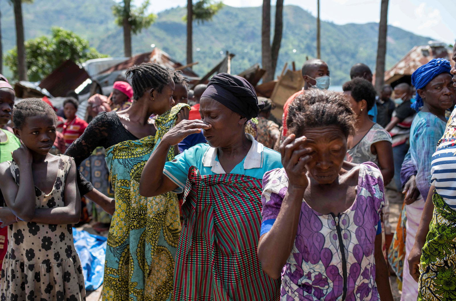 Congolese women react after the death of their family members following rains that destroyed buildings and forced aid workers to gather mud-clad corpses into piles in the village of Nyamukubi, Kalehe territory in South Kivu province of the Democratic Republic of Congo May 6, 2023. REUTERS/Stringer