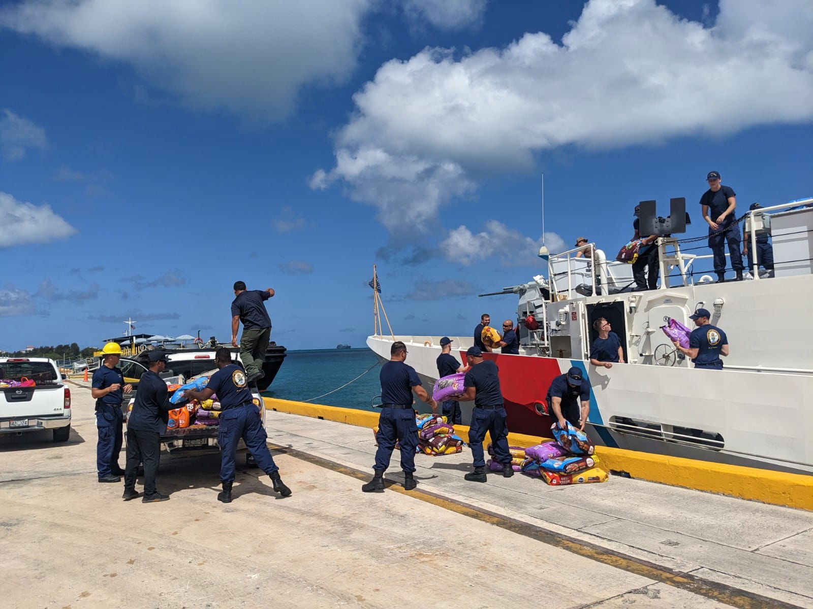 U.S. Coast Guard members unload their pet food donation.