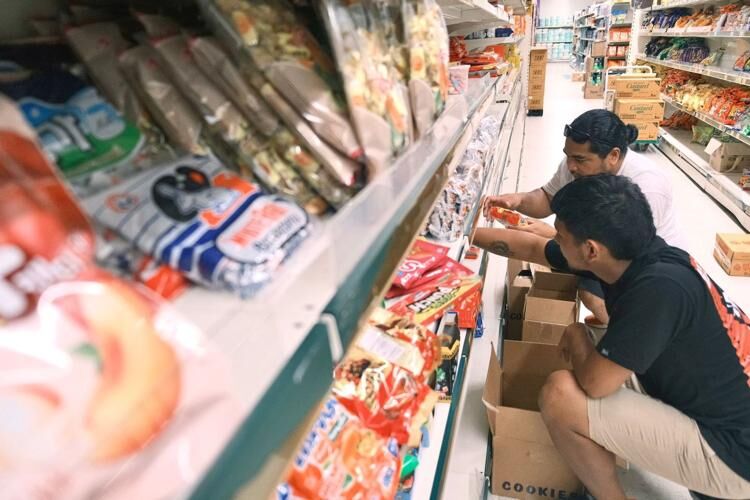 San Jose Supermarket employees stock shelves in the snack section at the Maite store on Tuesday, May 30, 2023.