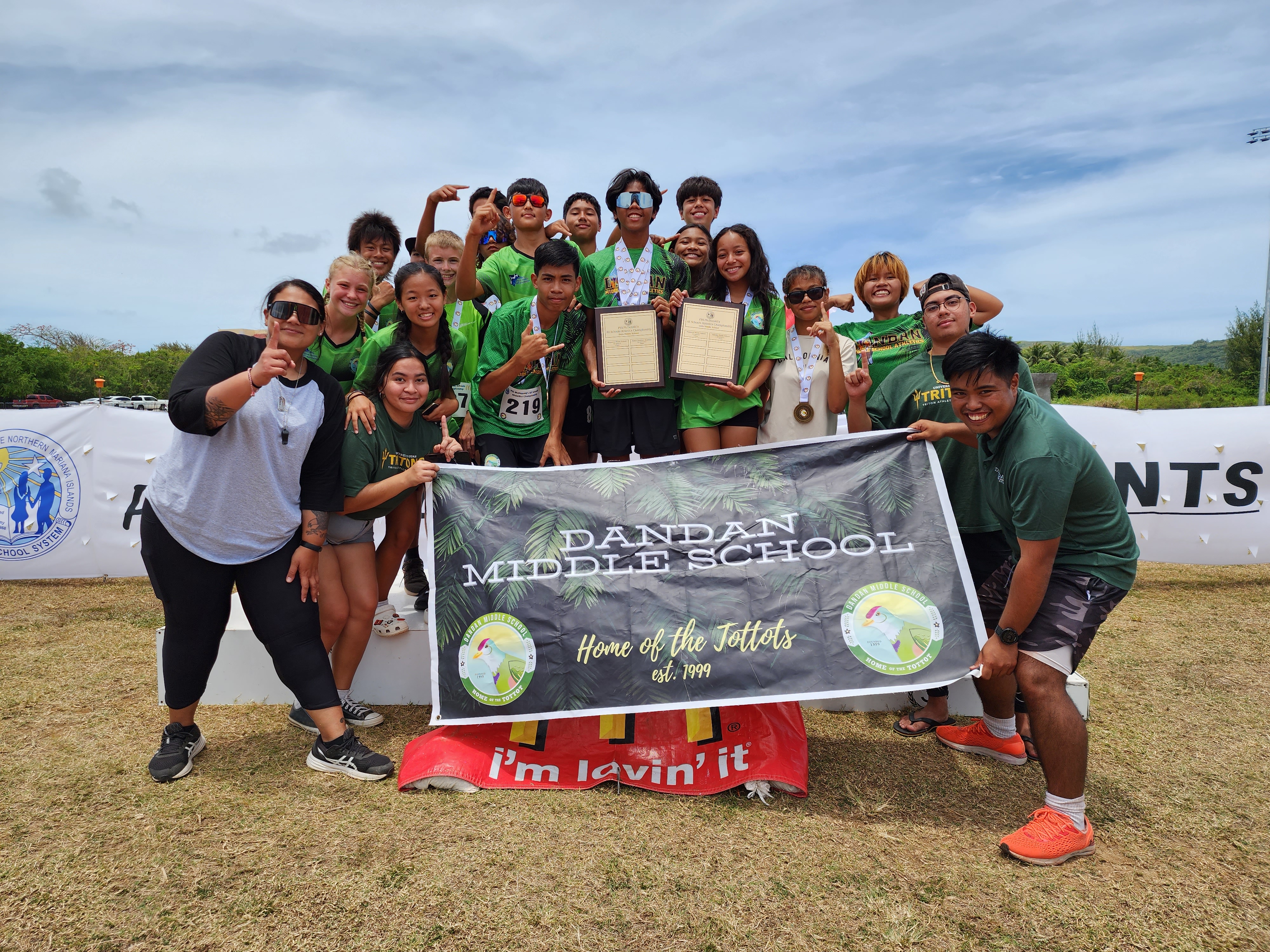 Dandan Middle School's U14 athletics team members pose with coaches Jeri May Tudela and Simon Necesito after winning the middle school division titles of the PSS-McDonald's All School Athletics Championships on Saturday at the Oleai Sports Complex.