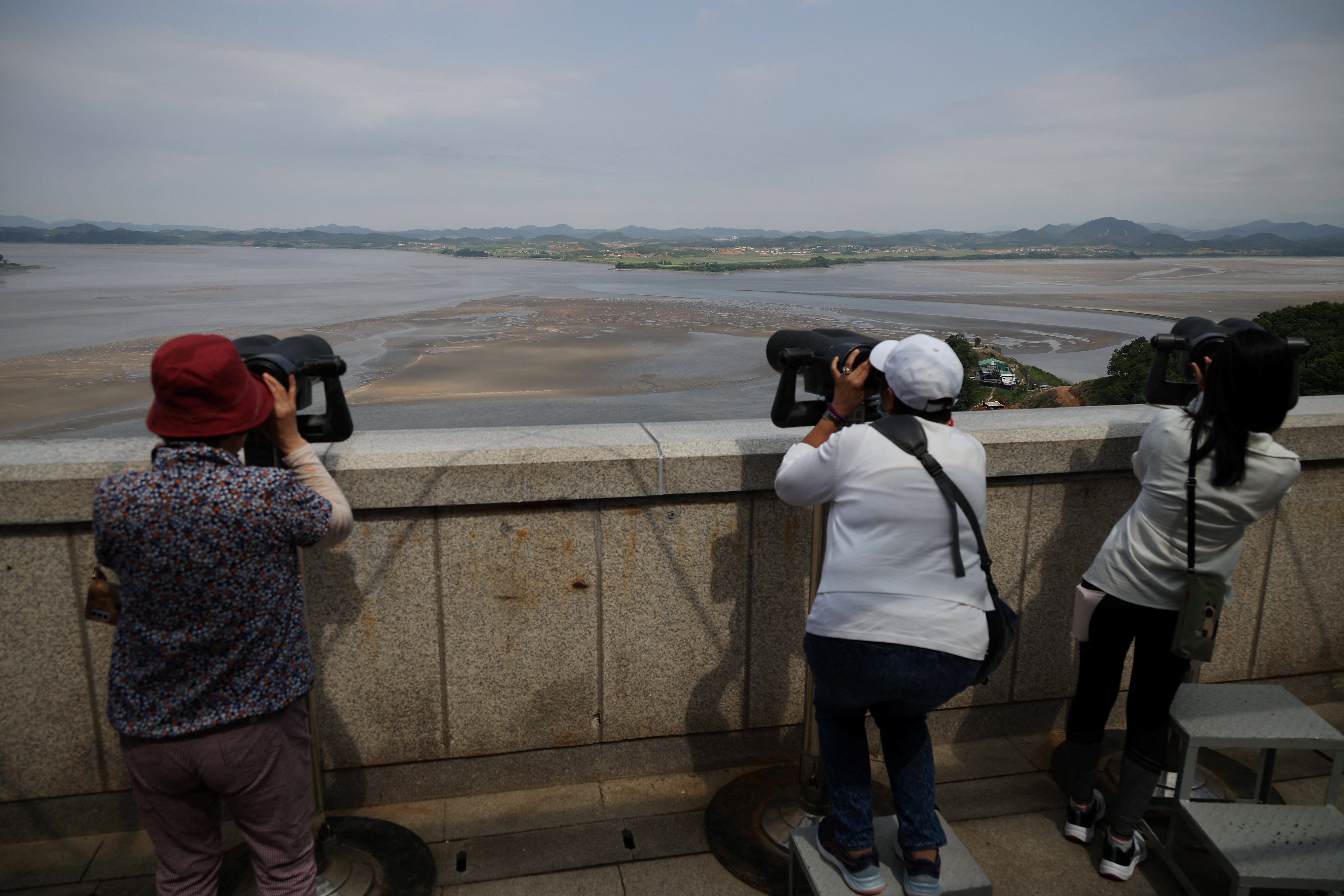 Tourists look toward the north from the Unification Observation Platform, near the demilitarized zone which separates the two Koreas in Paju, South Korea, May 31, 2023. REUTERS/Kim Hong-Ji