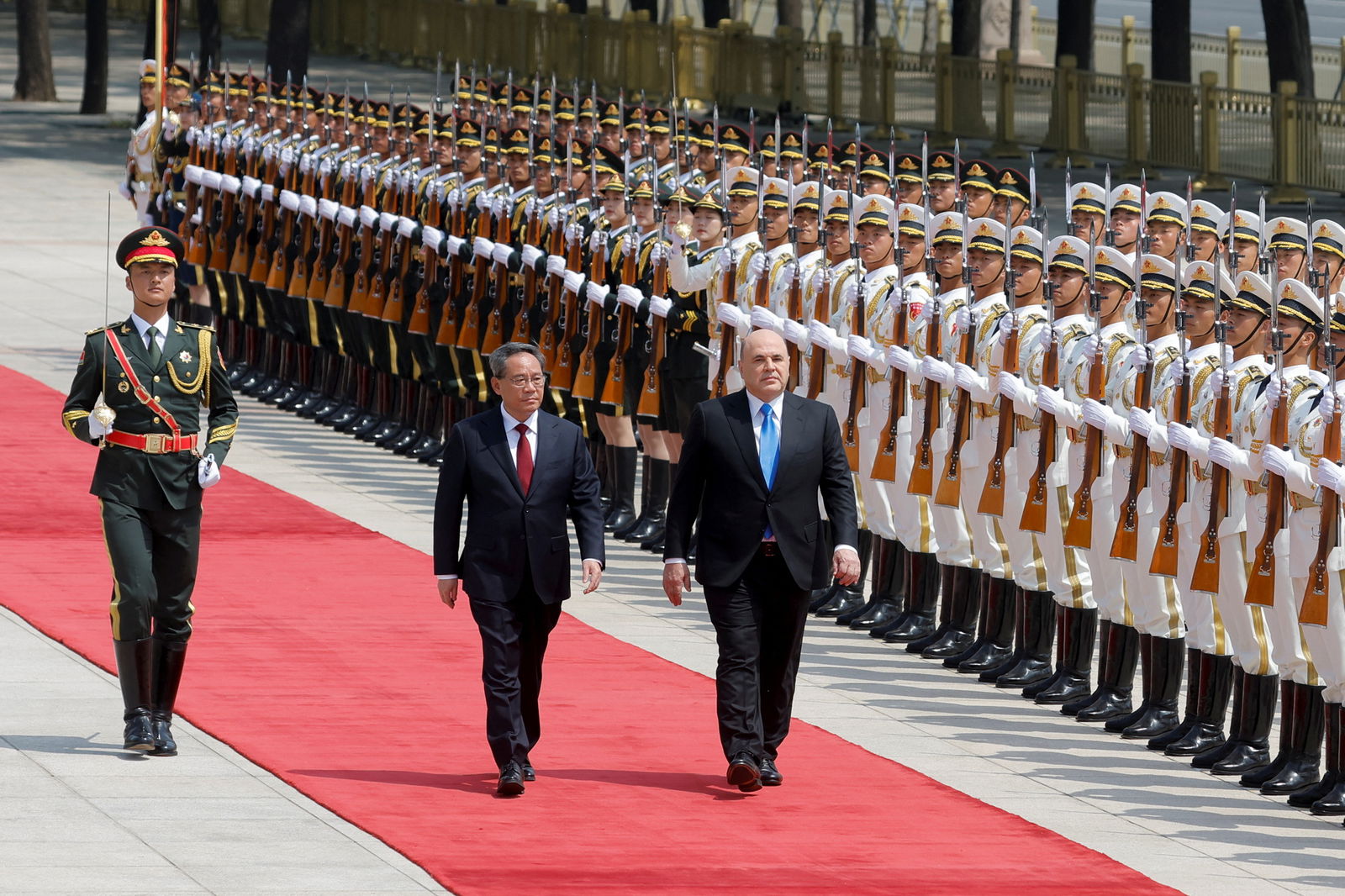 Russian Prime Minister Mikhail Mishustin and Chinese Premier Li Qiang attend a welcoming ceremony in Beijing, China, May 24, 2023. REUTERS/Thomas Peter/Pool