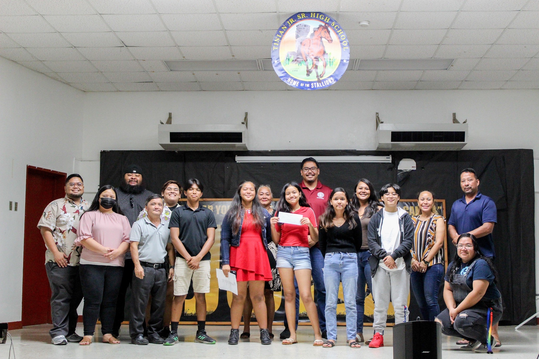 Youth Poetry Slam contestants pose for a photo with the PSS Mental Health Team and competition judges. From left, Kelvin Shrestha, Jianna Jireh Cruz (1st Place), Ava John (2nd Place), Quiana Manglona (3rd Place), Tehya Santos (3rd Place).