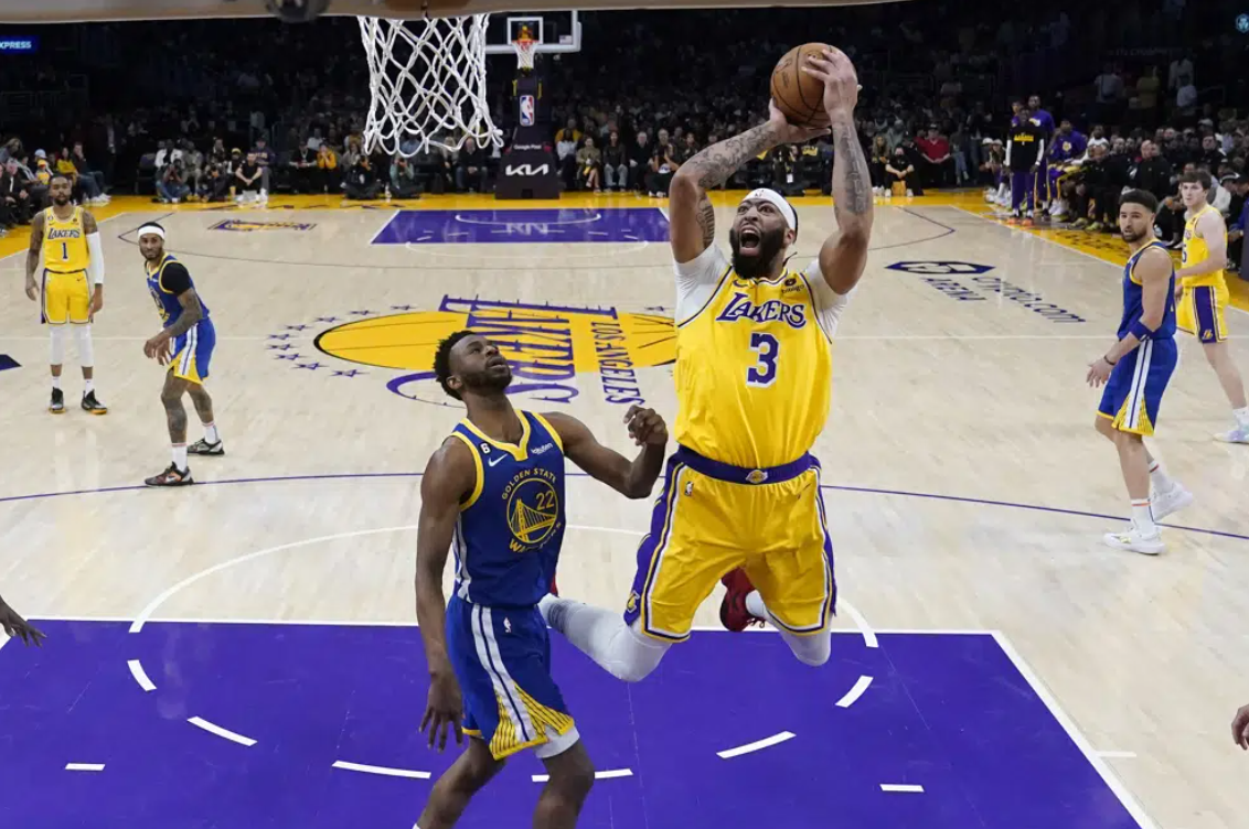 Los Angeles Lakers forward Anthony Davis (3) shoots as Golden State Warriors forward Andrew Wiggins defends during the first half in Game 4 of an NBA basketball Western Conference semifinal Monday, May 8, 2023, in Los Angeles.