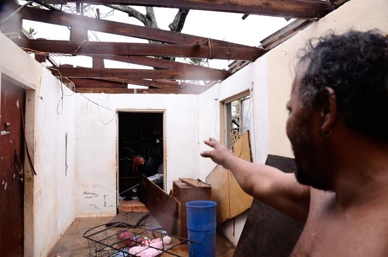 'I GOT SOAKING WET': Kenneth Babauta points to the laundry room where he stayed to wait out Typhoon Mawar after the roof on his home blew away. The rest of his family took shelter in a bathroom at the left of the room. John O'Connor/The Guam Daily Post 